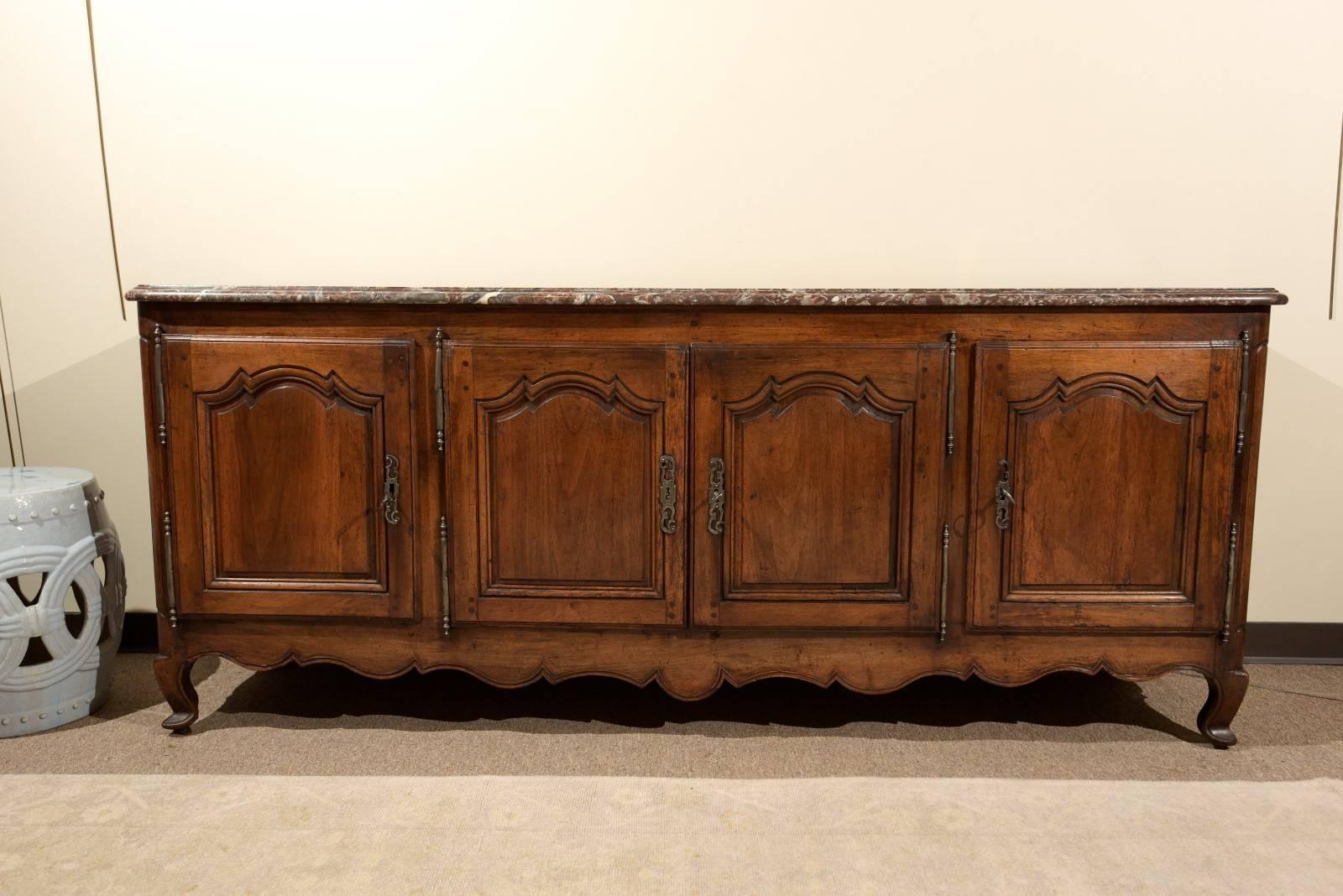 18th century Louis XV walnut enfilade, circa 1760
The beautiful enfilade was made in the Classic style of Louis XV furniture.
Due to it's length, the four doors are split with a pair in the middle and then the two ends open individually. The walnut
