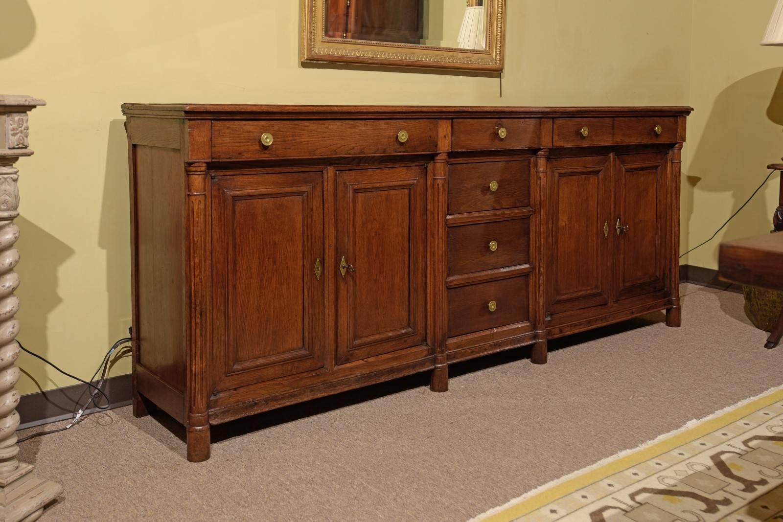 19th century Empire period enfilade, circa 1820.
This enfilade has a lot of storage with four drawers down the middle, drawers across the top and ample room underneath. Although it is Empire style the piece is made of oak and has a more relaxed