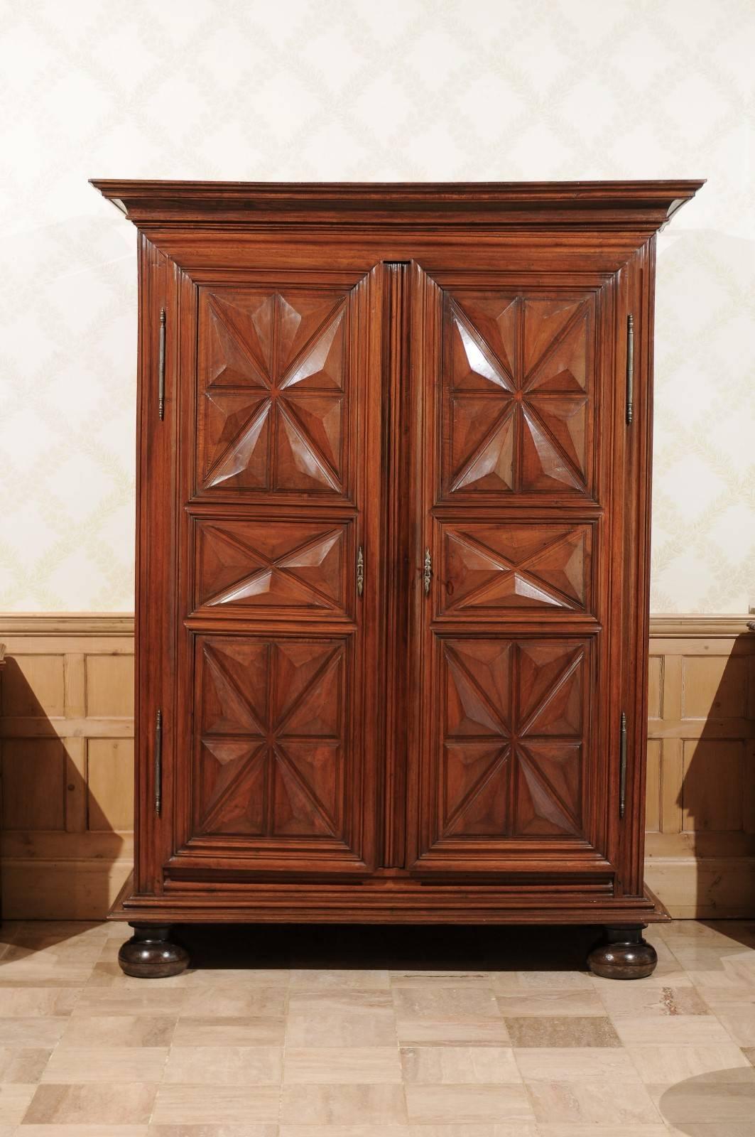 18th century period walnut Louis XIII Armoire, circa 1780
The point de diamond pattern of the Louis XIII period is quite impressive. The carving is deep into the wood and a wonderful geometric design. The 
 large bun feet also accentuate the size