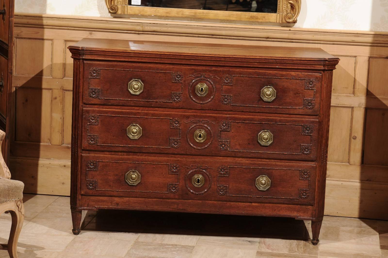 18th century Louis XVI carved oak commode, circa 1780
Although the Louis XVI style dictates straight lines, this chest has lots of feminine details. The dainty bows surrounding the escutcheons and the pretty carved flowers adorning all the drawers
