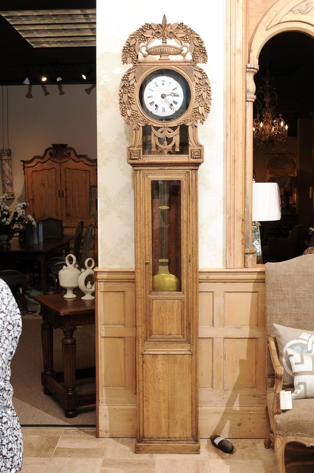19th century carved oak tall case clock from Normandy
This type of clock is called a St. Nicolas clock as it was made in St. Nicolas-d' Aliermont near the Normandy coast. This style is known for the beautiful carved headdress surrounding the face