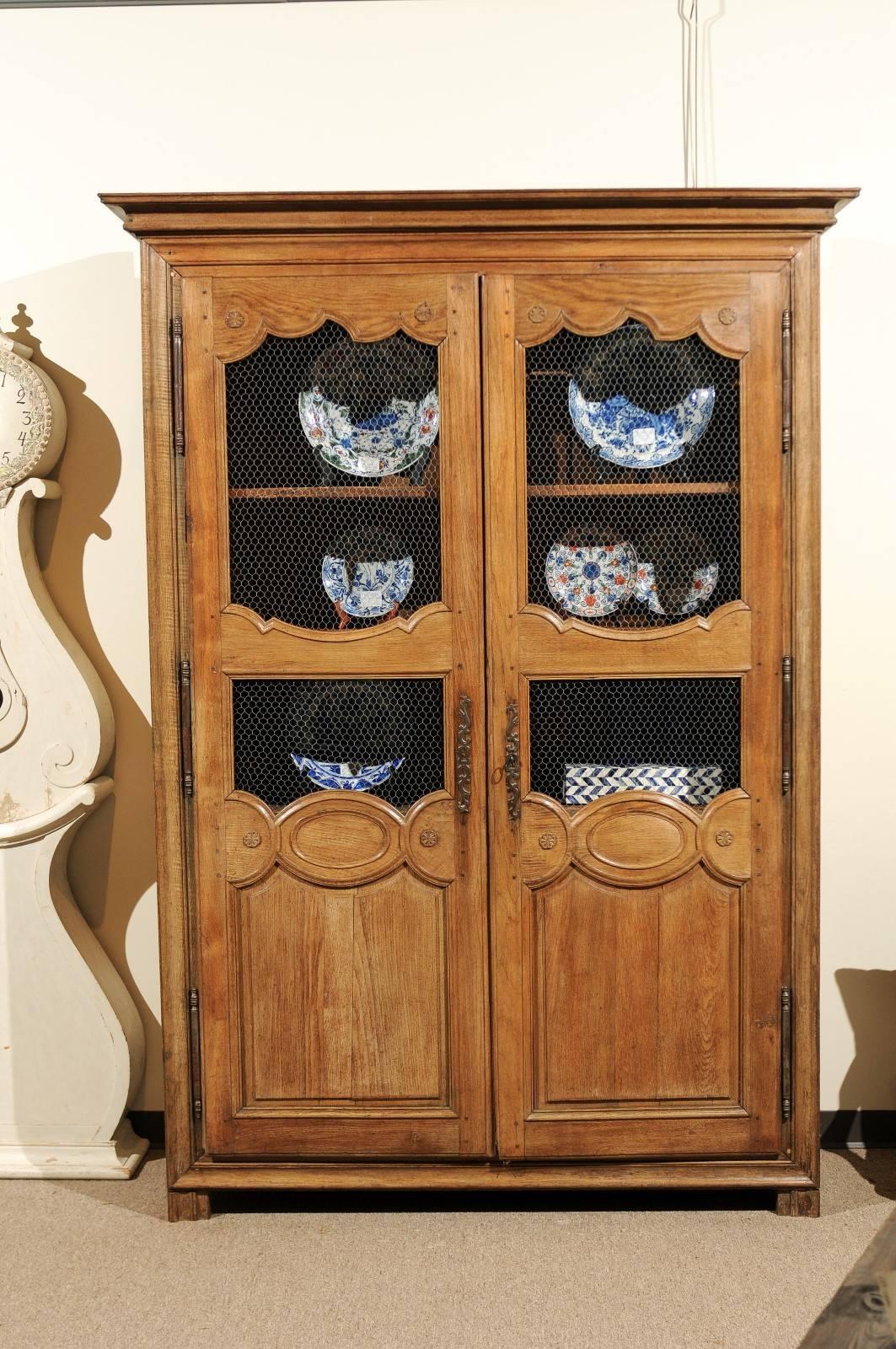 19th century French armoire, circa 1890
This is an attractive armoire we found in Brittany. The chicken wire has been added to give a different use to the piece. The open look affords the owner some flexibility as to the use. The straight lines and