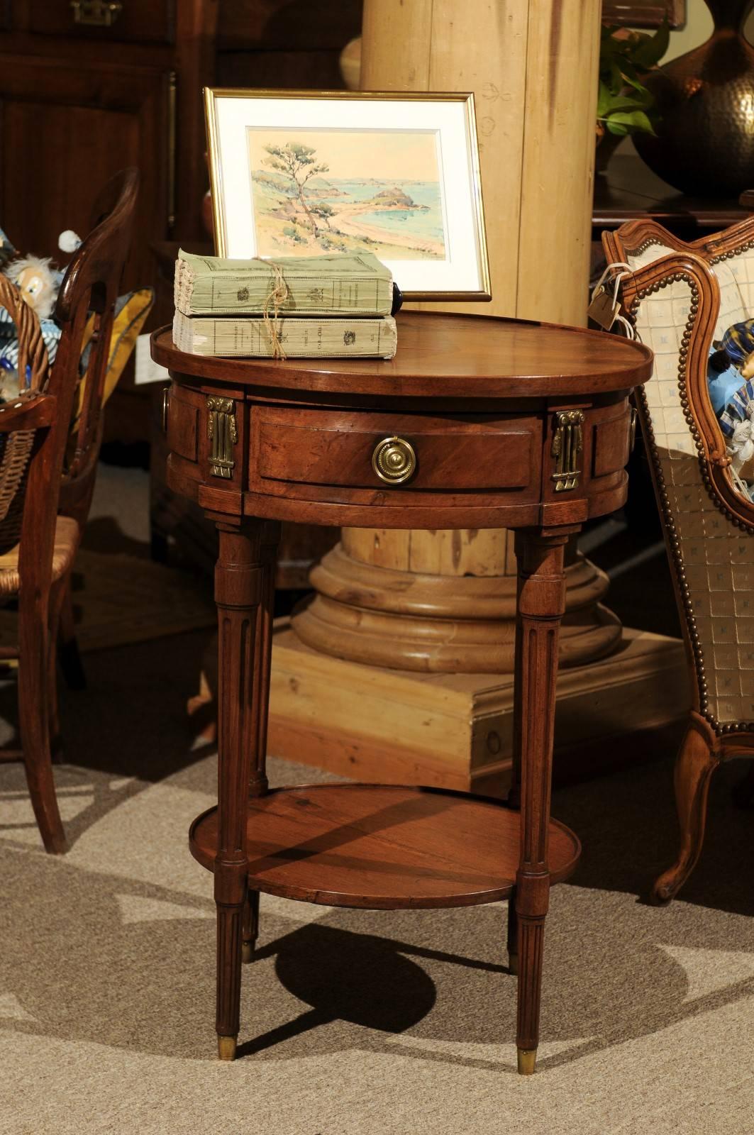 19th century walnut Louis XVI style Gueridon, circa 1880
This dainty little gueridon is so useful and just a little dressy. It has one drawer and three false drawers. The pulls and decorative pieces which adorn the apron are bronze. The walnut is a