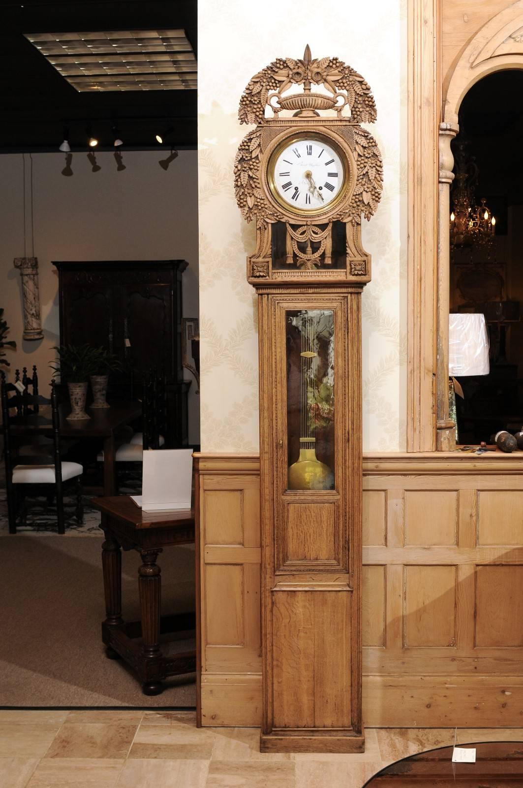 19th century carved oak tall case clock from Normandy

This type of clock is called a St. Nicolas clock as it was made in St. Nicolas-d' Aliermont near the Normandy Coast. The style is known for the beautifully carved headdress surrounding the face