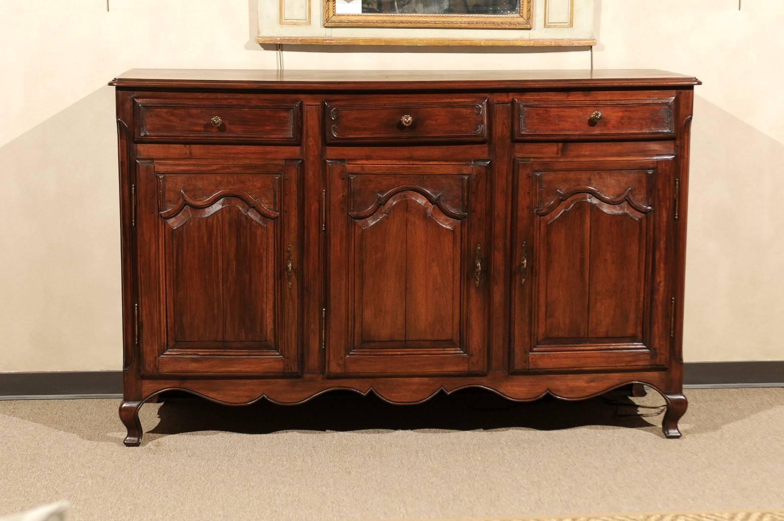 19th century walnut enfilade with three doors and three drawers, circa 1870

This enfilade has a very handsome profile and a wonderful patina on the dark walnut. These days, our clients like to use a piece like this under their large televisions