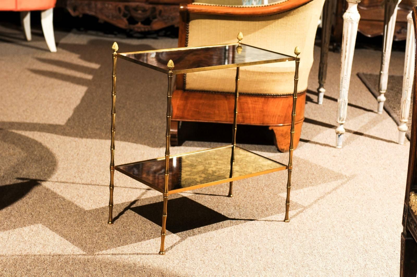Midcentury Baguès style bronze and mirrored side table
This very useful table adds the contemporary look to your room. The bronze legs and acorn finials give this table an elegant look. Both the top and the shelf are mirrored. It would be lovely by