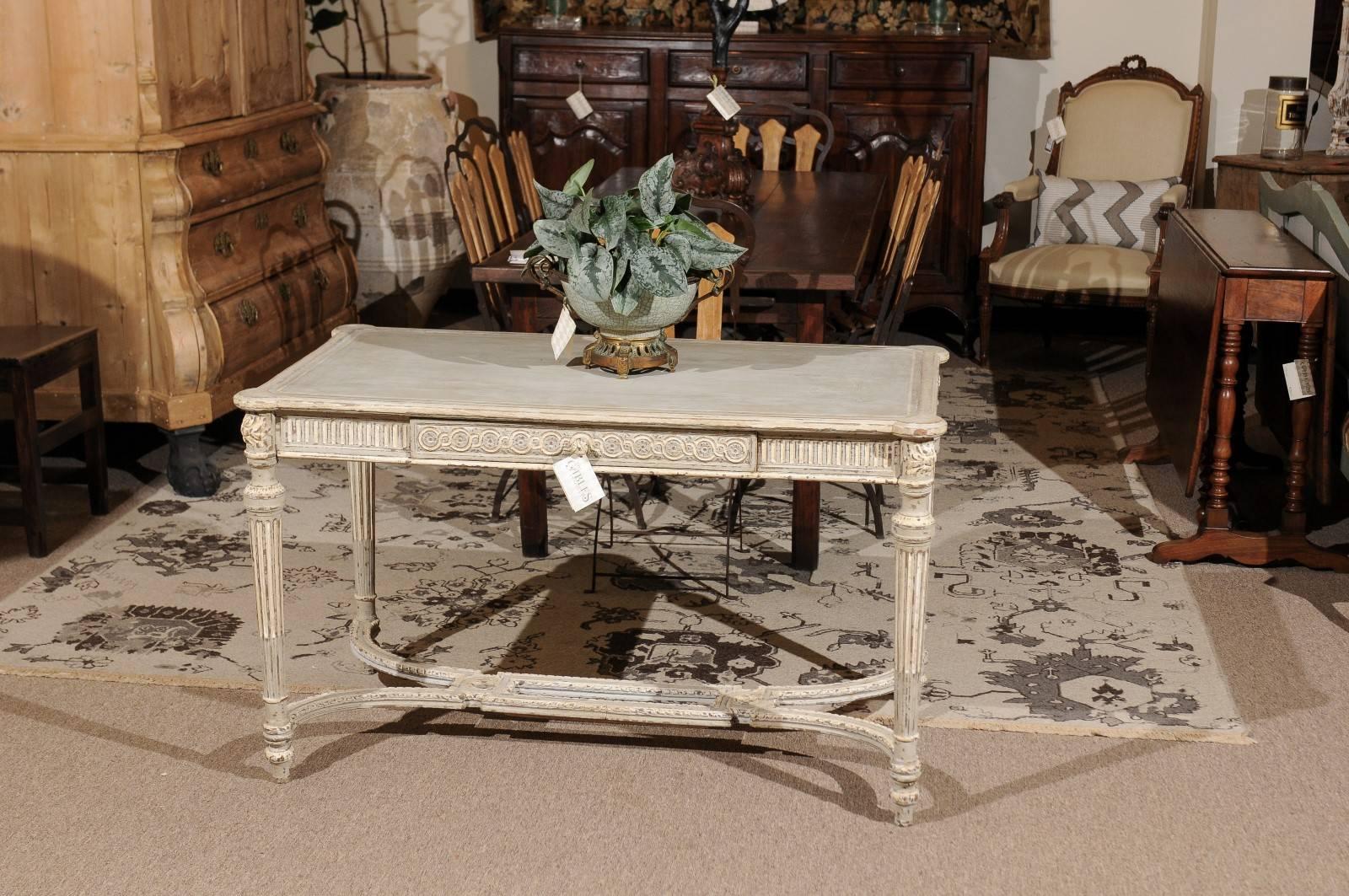 19th century Louis XVI style painted center table

This wonderful carved center table began life as a dark oak piece but was brought up to date with a very well done painted finish. We bought it already painted in the area of France near Belgium and