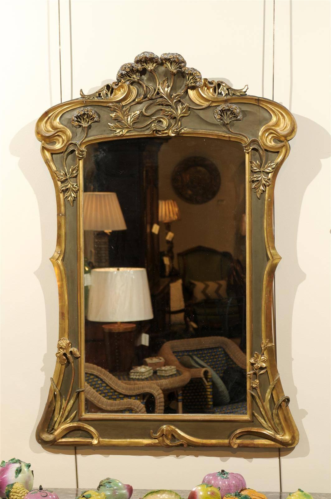 Art Nouveau style mirror in gold and taupe, circa 1950
Flowers, flowers everywhere! Our Art Nouveau style mirror has many flowers that adorn the frame and add a great deal of movement. What fun!