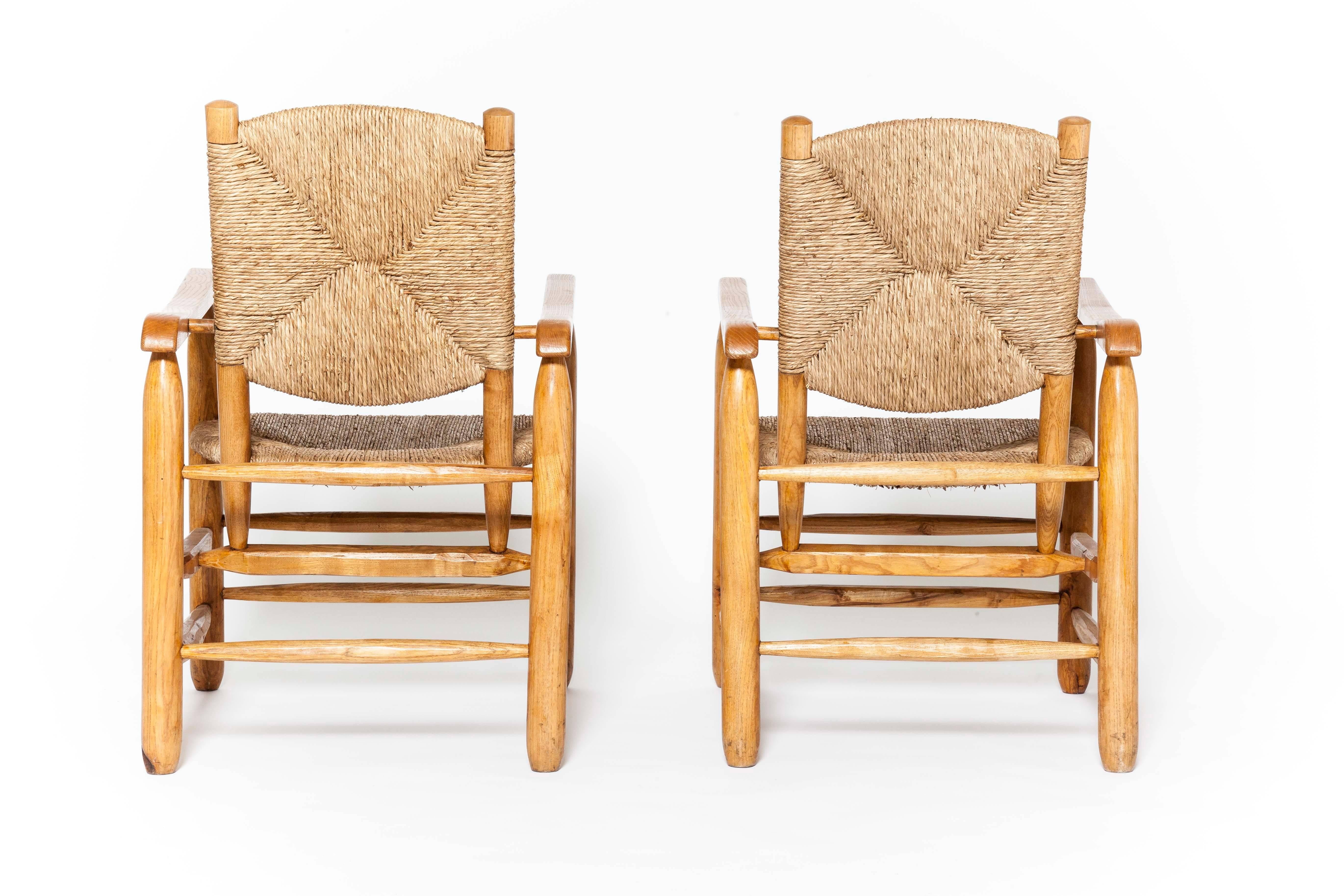 Charlotte Perriand, pair of rush armchairs.
Wood, rush.
