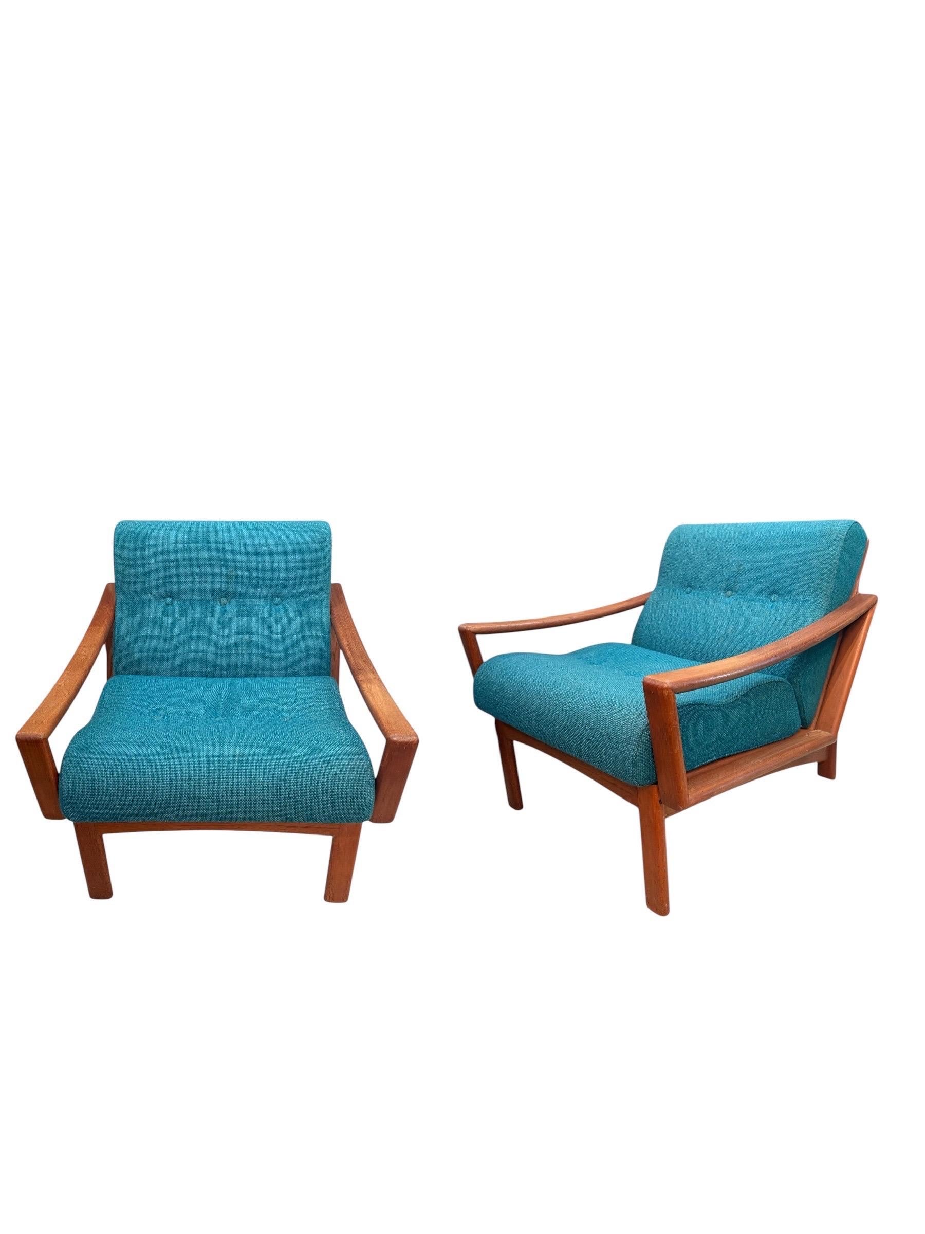 Elevate your space with this stunning pair of original 1970s teak lounge chairs by renowned Danish manufacturer Glostrup Møbelfabrik. A true testament to the timeless appeal of mid-century modern design, these chairs showcase the clean lines,