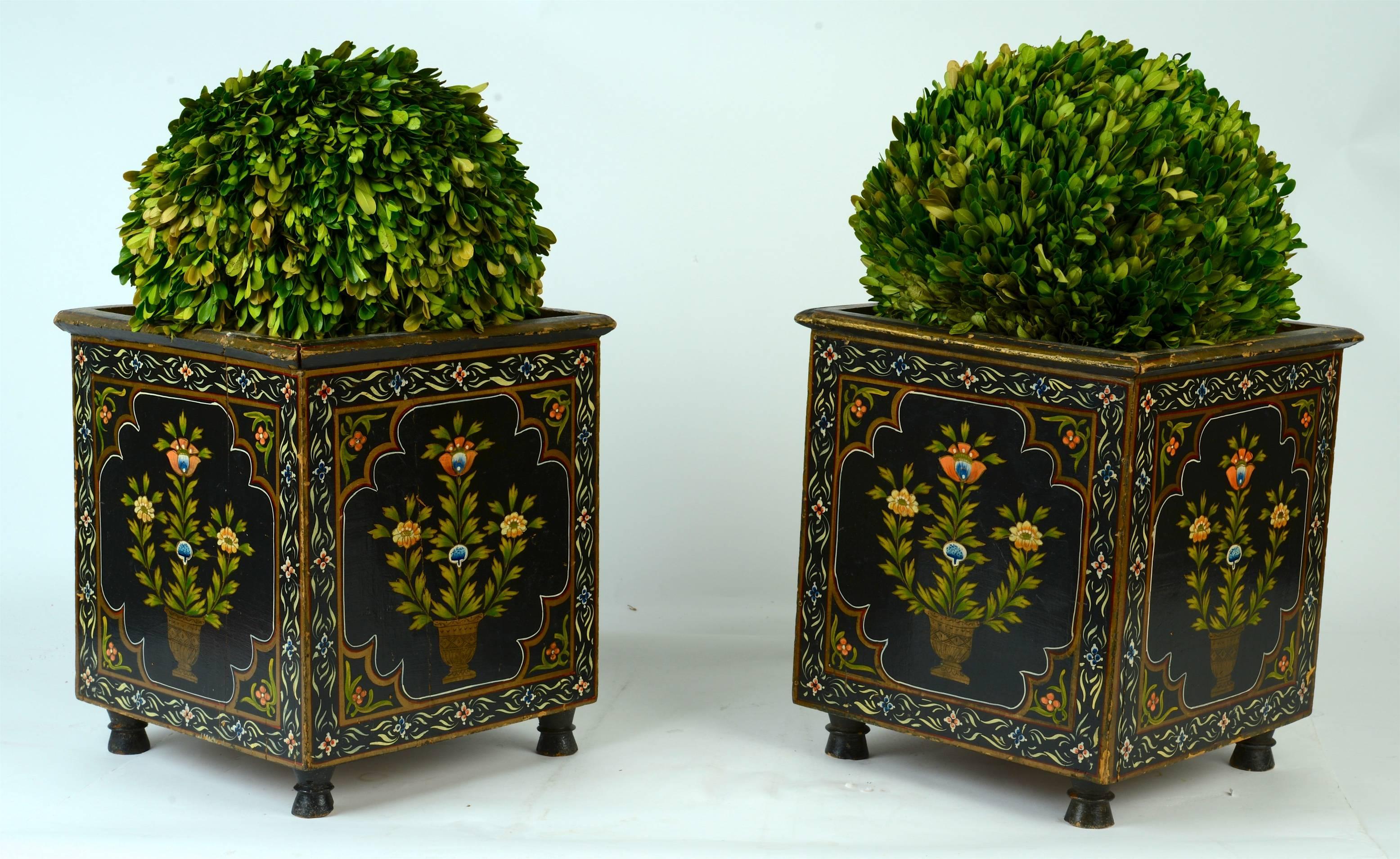 Pair of 19th c painted planters. The wood frames with original poly-chrome decoration of stylized flowers, are raised on turned feet. Both planters have custom-made tole liners. They appear to be Dutch. Topiaries are shown for reference and not