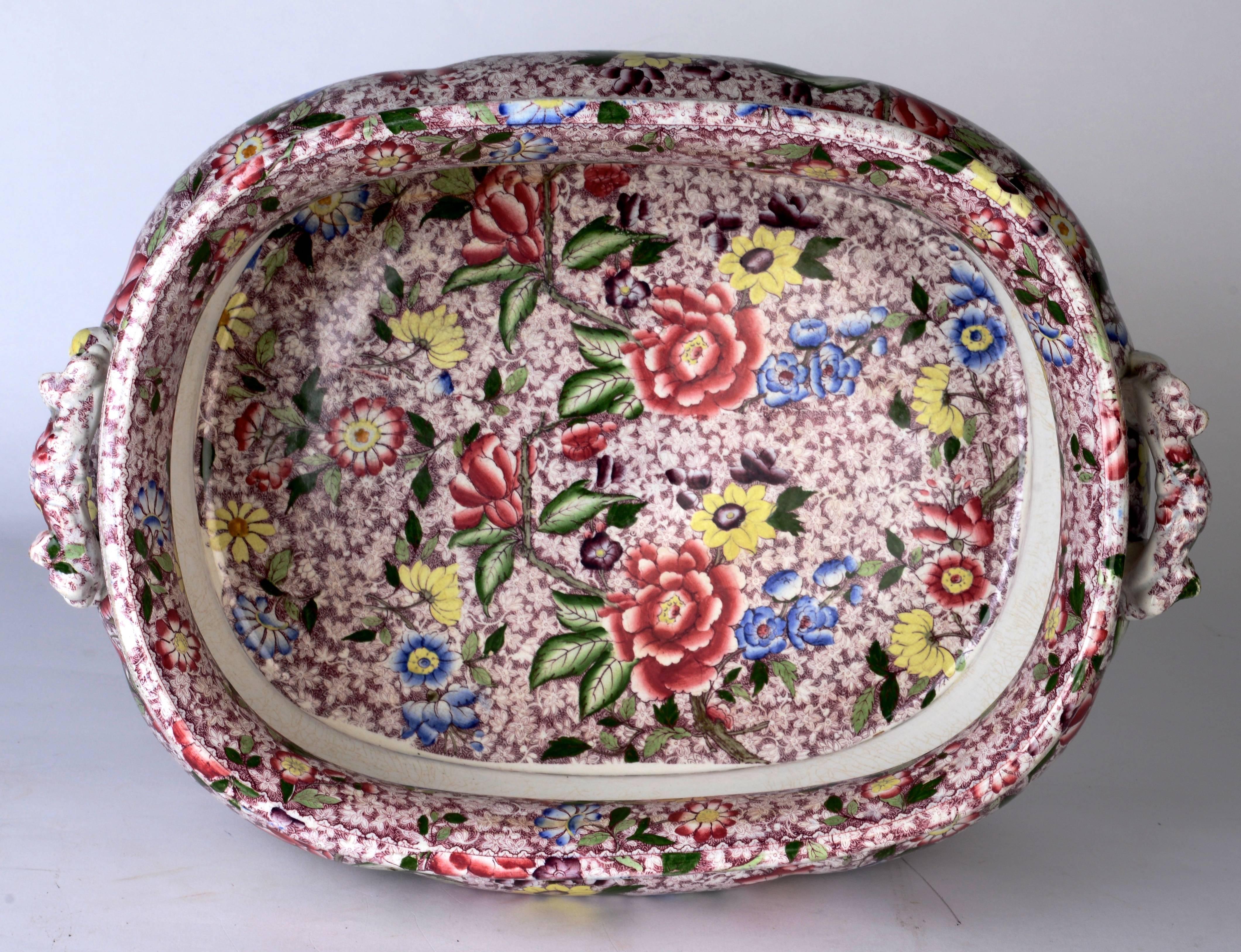 Victorian, transfer printed and hand-painted, ironstone foot bath, circa 1880 with decorative molded handles, unusual pink chintz transfer pattern with fine grace and movement accented by defined brushstrokes in brilliant colors, it is unusually