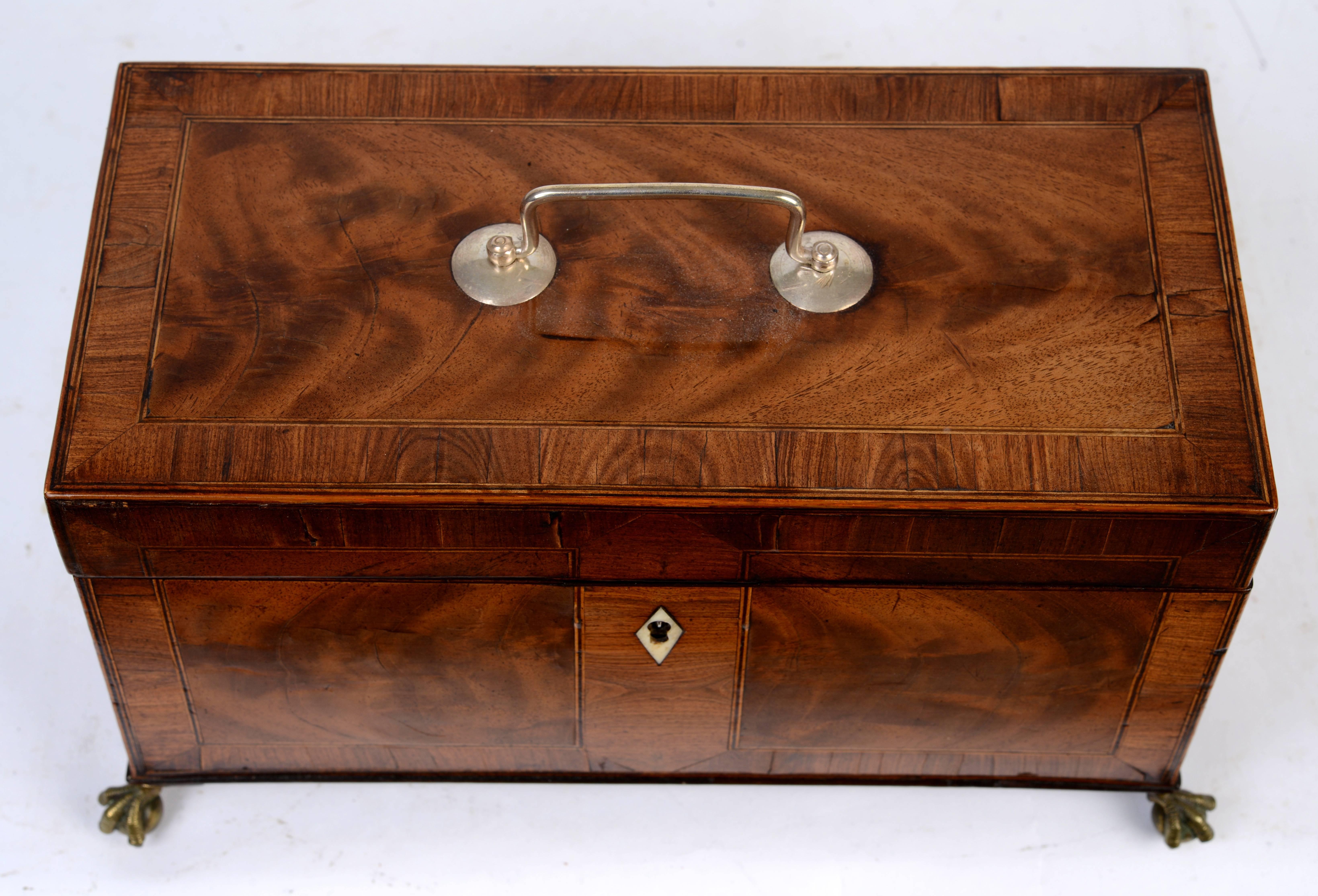 Chippendale tea caddy, c1770, burl veneered mahogany paneled front and sides with cross banded border raised on original ball and claw cast brass feet. The two interior compartments, each with a hinged burled mahogany cross-banded lid, still retain
