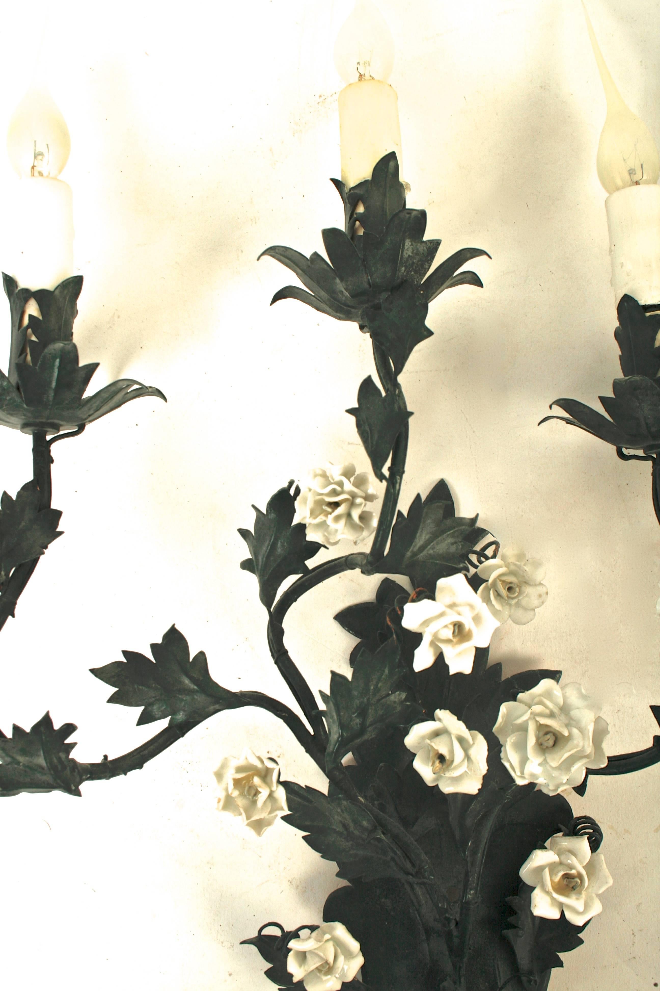 This pretty pair of French black tôle sconces with three branches of porcelain flowers and metal leaves. The three arms have leaf bobeche and are supported on an acanthus leaf bracket. A unique pair for a clever décor.
N.P. Trent has been a