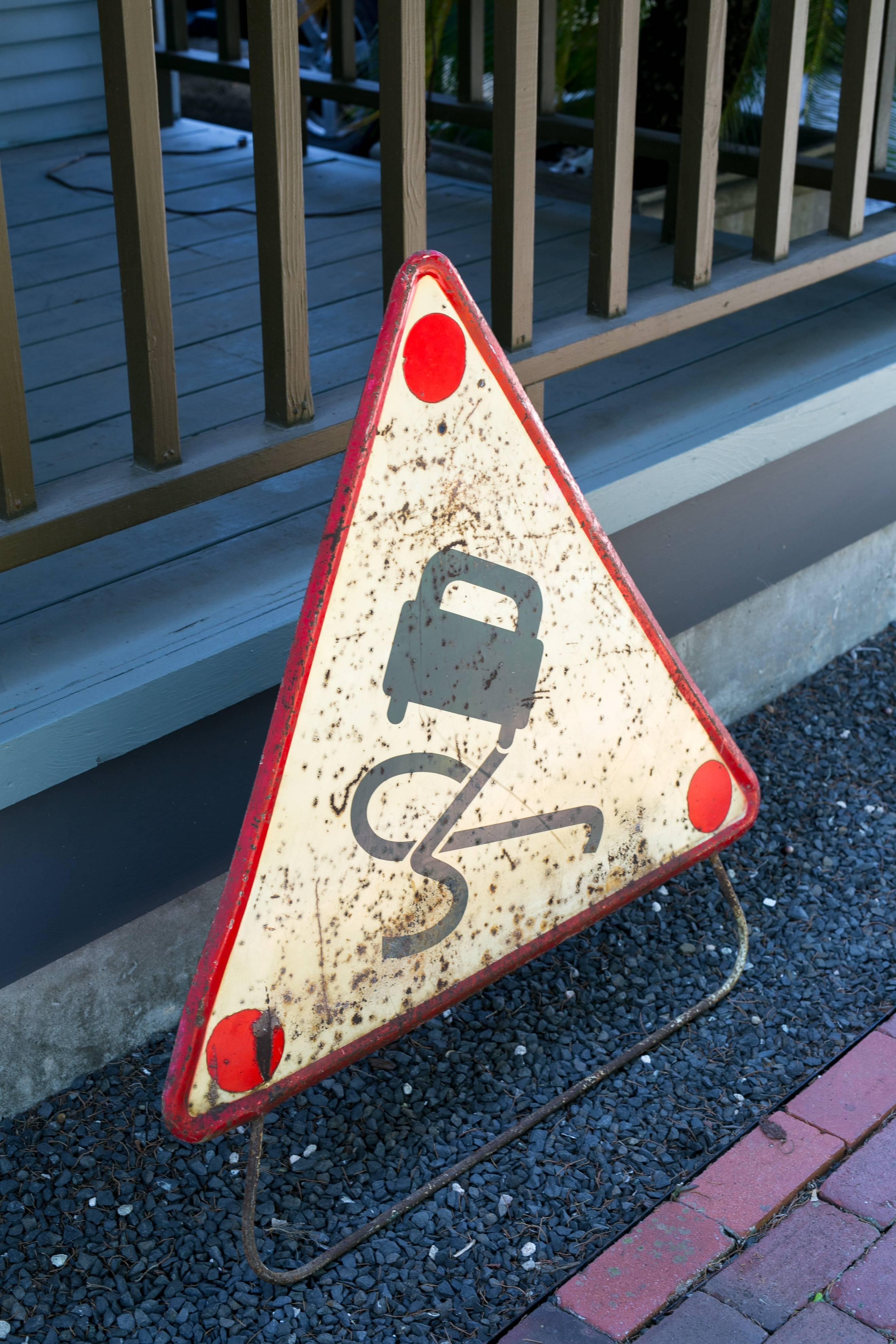 Hand-painted red, black and white triangular metal road safety sign from France, circa 1920s-1930s. Comes with iron stand attached, as it would have been used on the street to warn motorists. Wonderful colors and graphics. Quite large in scale.
