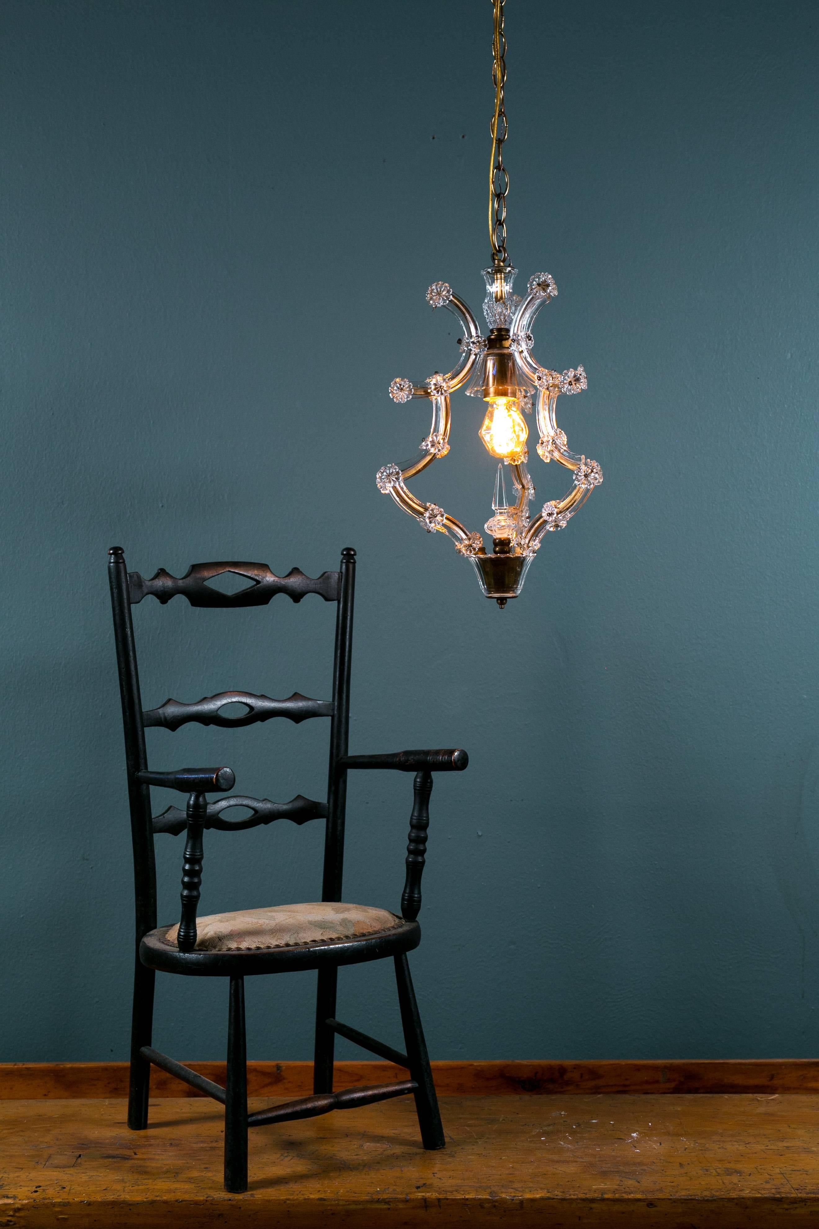 Antique, carved-wood, all original black painted child's arm chair with floral upholstered seat and brass nail heads. Excellent condition for it's age. Light fixture shown in photo #2 is not included.