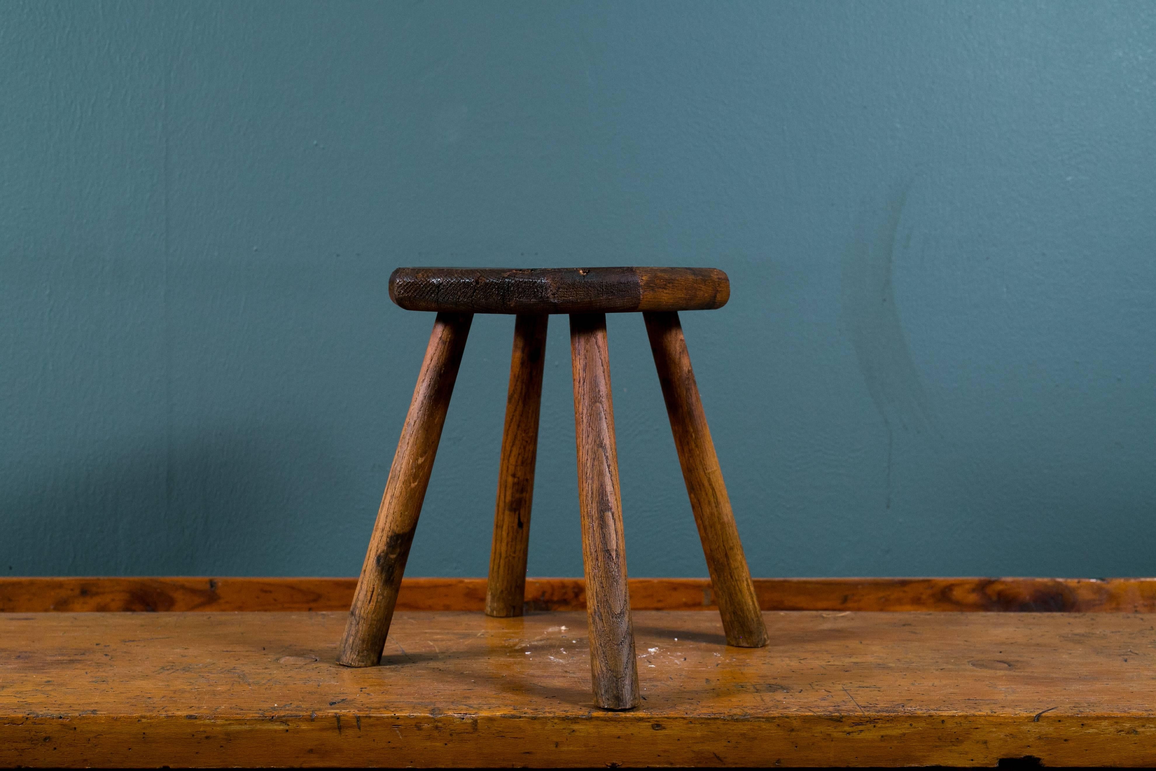 Charming, Primitive small oak stool. All hand-carved and handcrafted in a rustic style. Top features squared off corners to make an octagon. Would be great as a low bedside table.