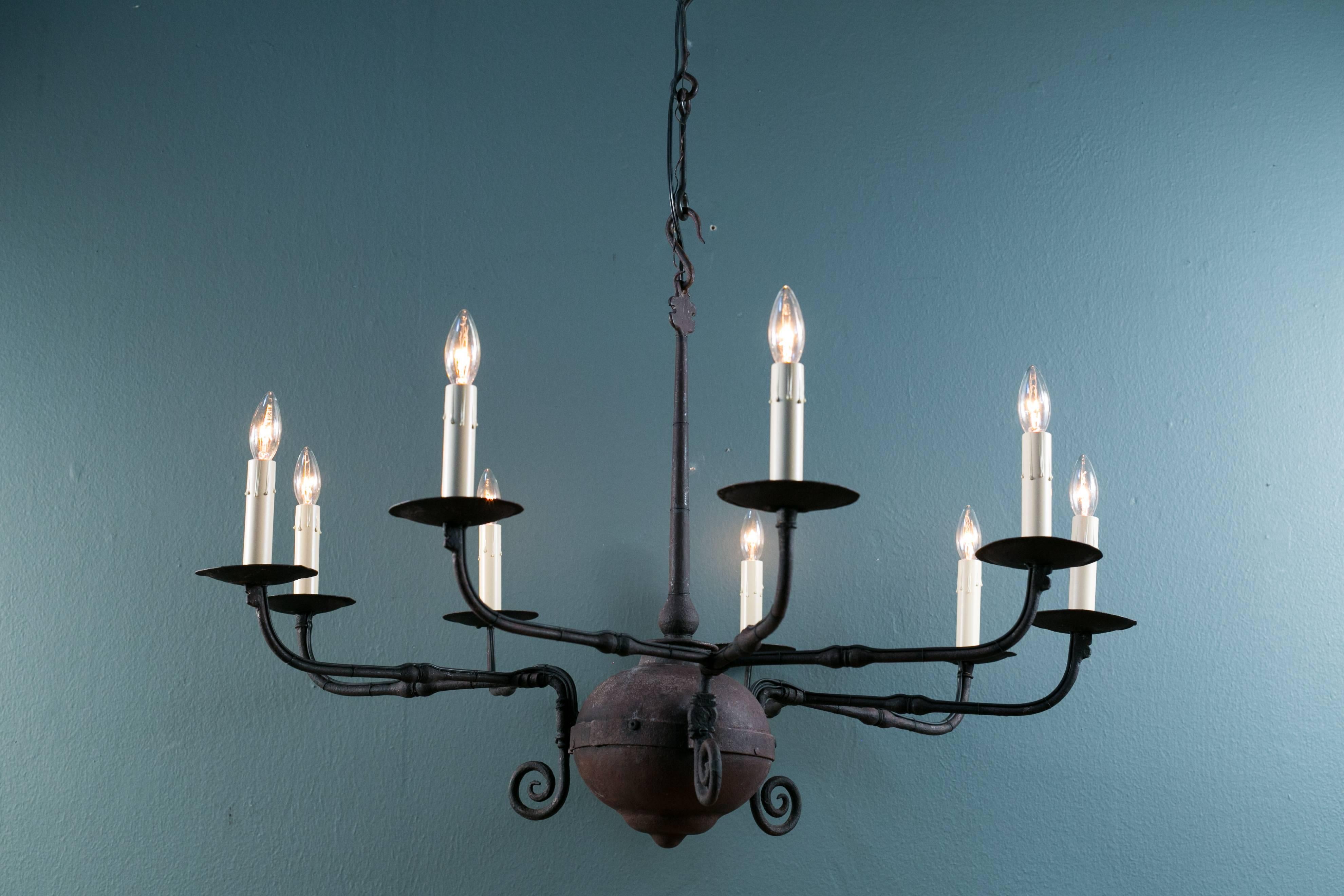 Handcrafted forged wrought iron chandelier, newly rewired with all UL listed parts and nine candelabra sockets on three arms. In the style of George V. Comes with handmade iron chain and canopy.