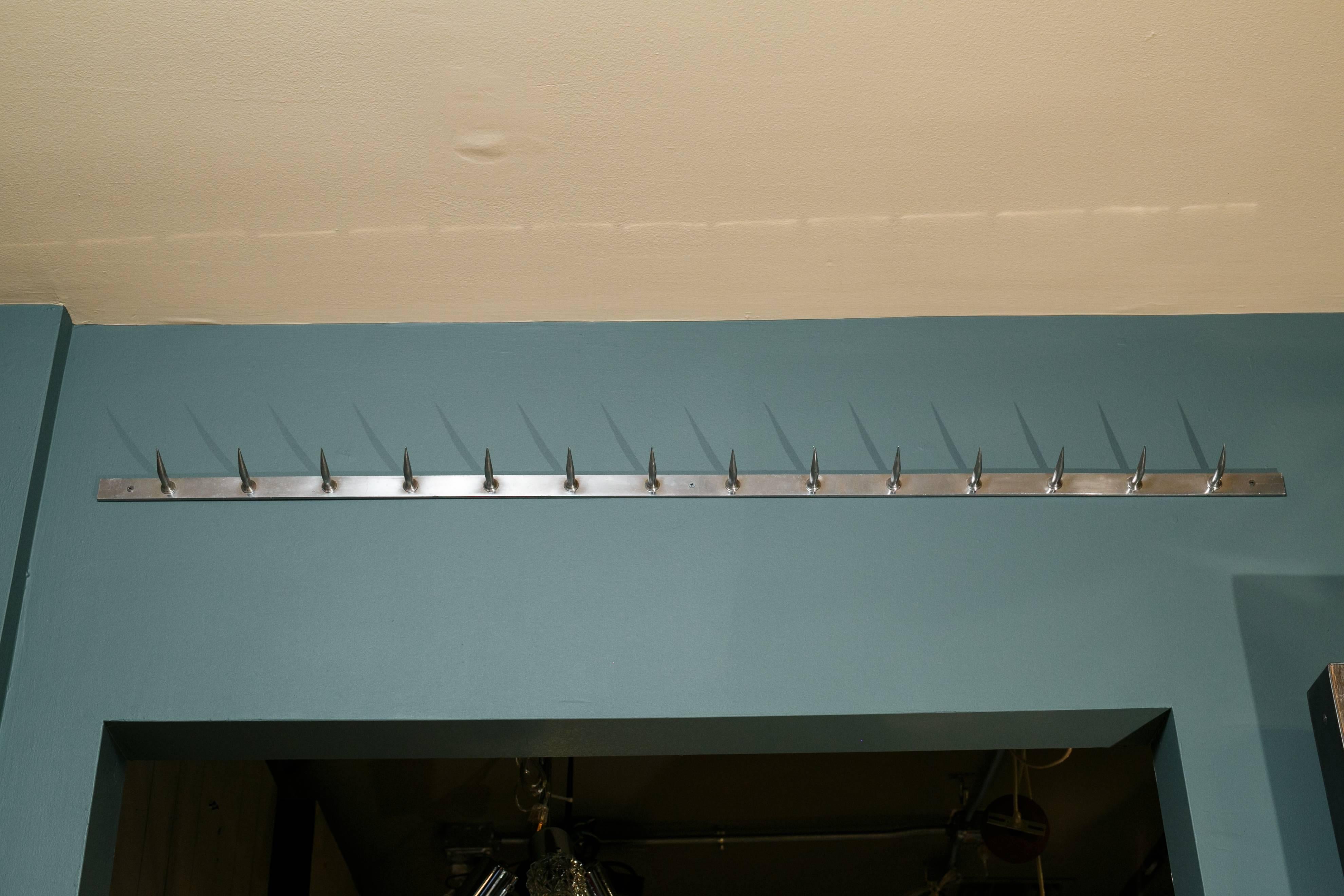 Long chrome pot rack with fourteen stationary hooks. Was in a French butcher shop. Bar is 1.25 inches high, measurement listed is from top of hook to bottom of bar.