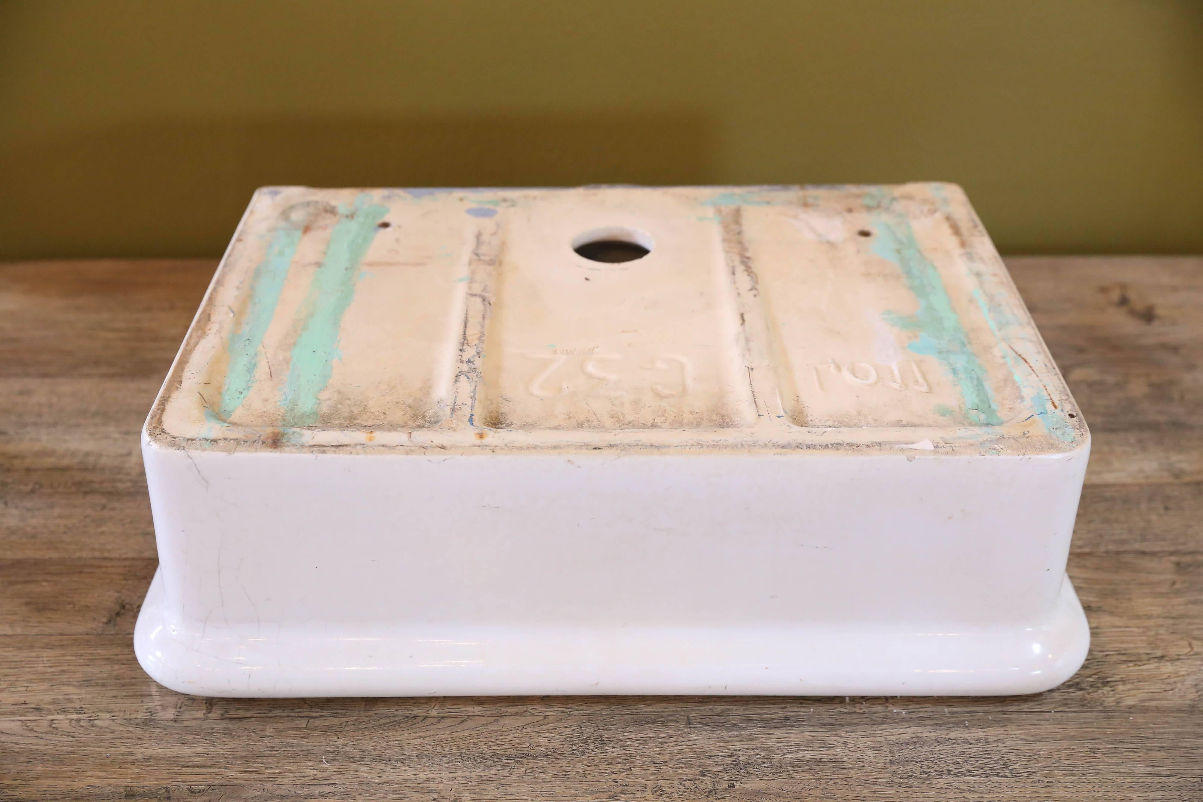 Antique white porcelain sink with drainage hole. From France, circa 1920. Flat back with rounded square edges. Inside of sink measures 5.5 inches deep.