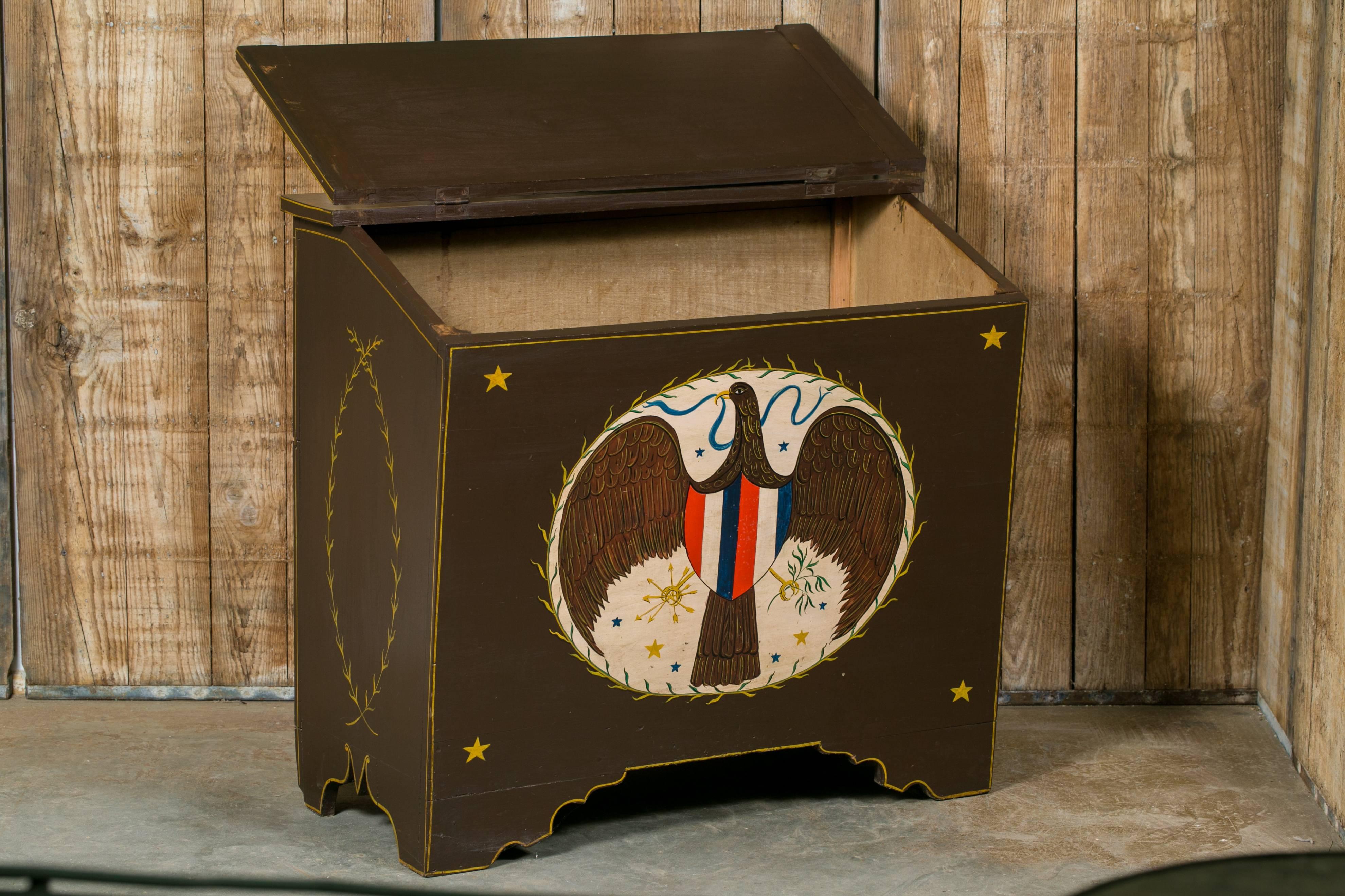 Antique Americana style North American blanket chest with hinged lid, circa 1900. Hand-painted with a stylized Federal Eagle on the front. One talon grasping arrows and the other an olive branch. Fruit motif on the top with two cornucopia. Painting