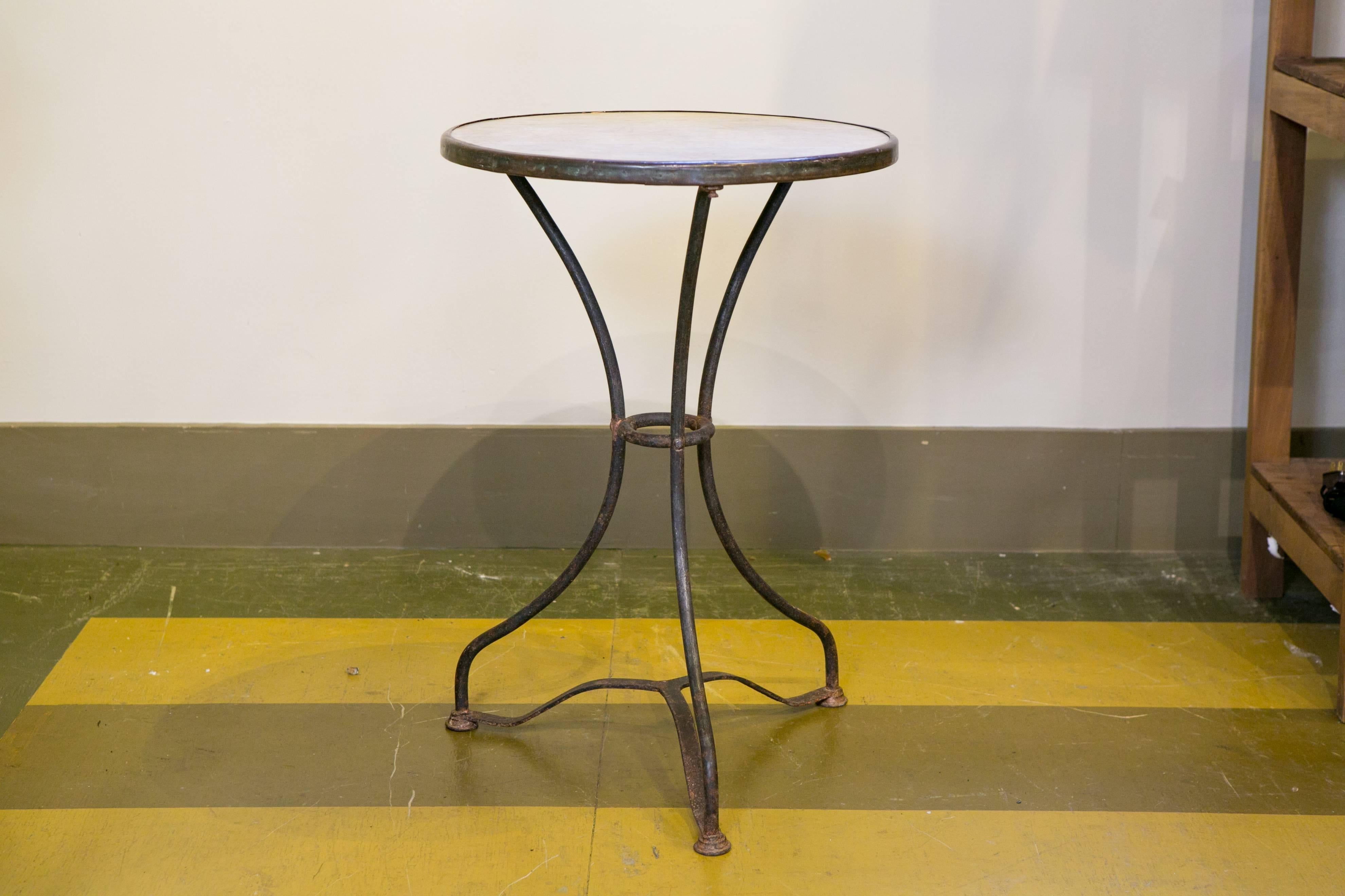 Antique French gueridon table with marble top, brass band and iron base. Classic style with great proportions.
From France, circa 1900.