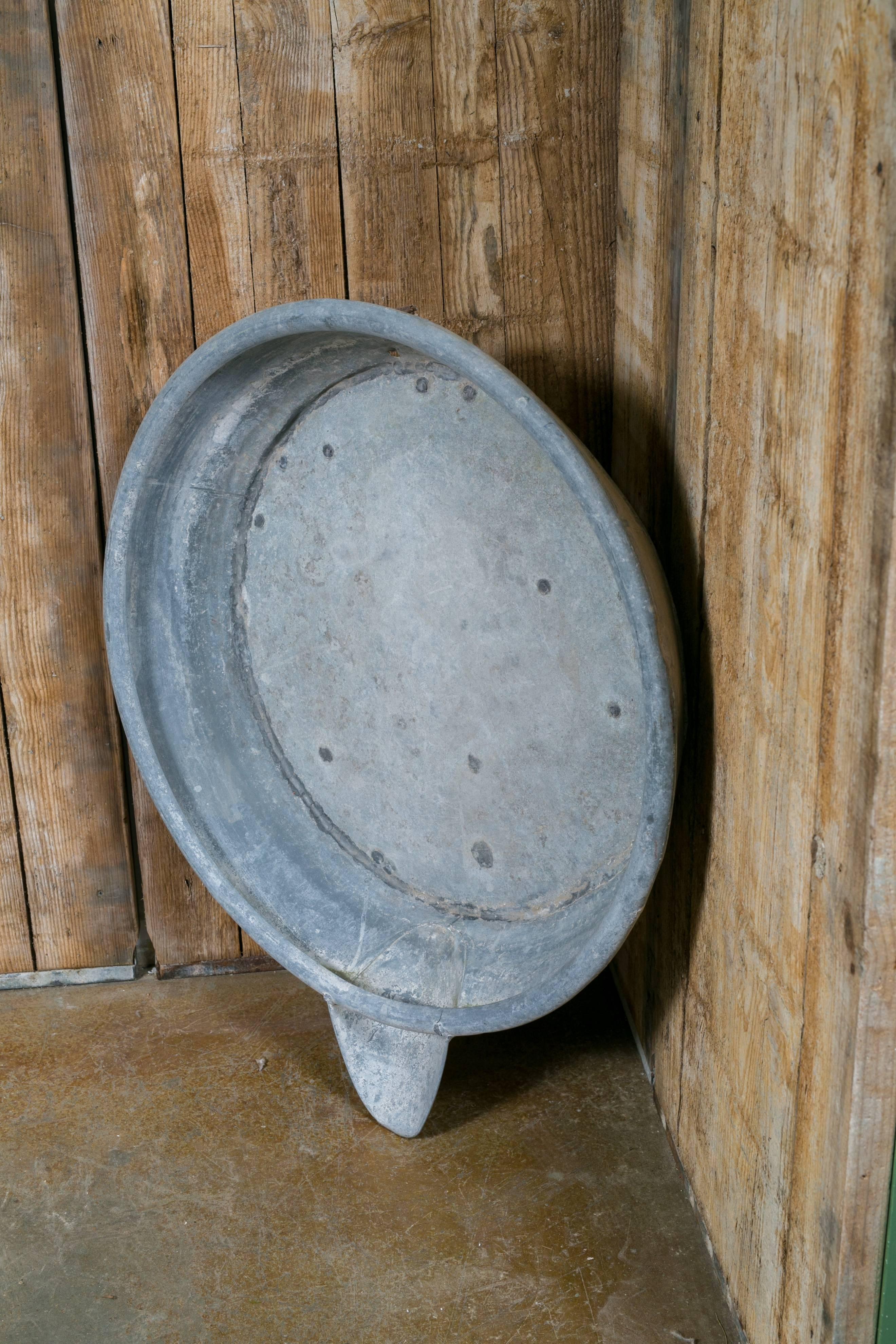 Vintage large Belgian Industrial saucer with spout. Handcrafted zinc construction with a hook on the back for hanging. We believe they were some sort of cream or milk separator. Makes a great wall decoration.