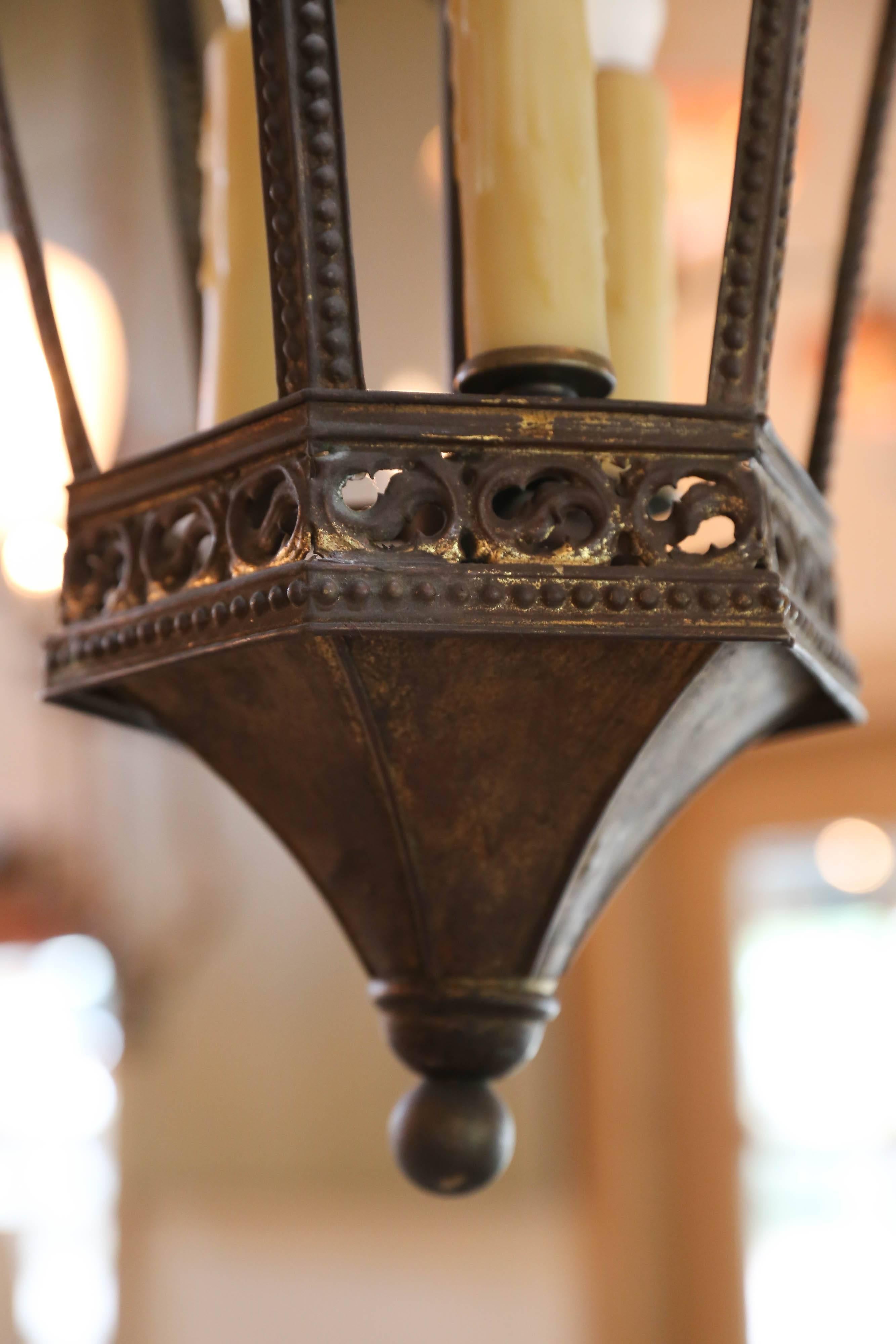 Wonderful near-pair of Gothic Revival lanterns from France, circa 1900. Newly wired with all UL listed parts and three candelabra sockets per fixture. Beautiful casting on the brass with incredible detail and quatrefoil cutouts on the roof. Comes