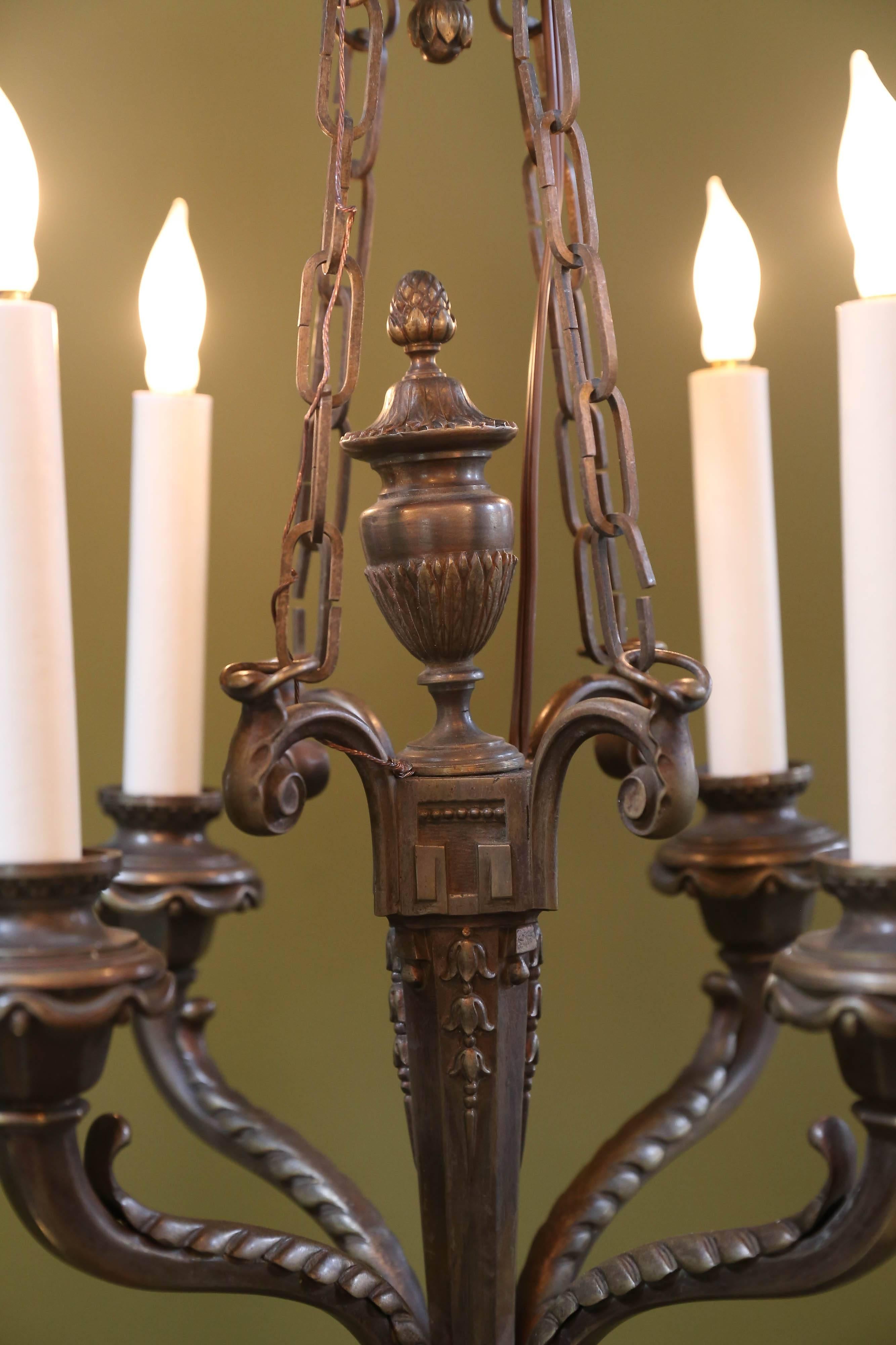 Beautifully cast, heavy bronze chandelier from France, circa 1890. Newly wired with all UL listed parts and four candelabra sockets. Height listed is to the top where the chains connect. There is an additional length of chain and beautiful cast