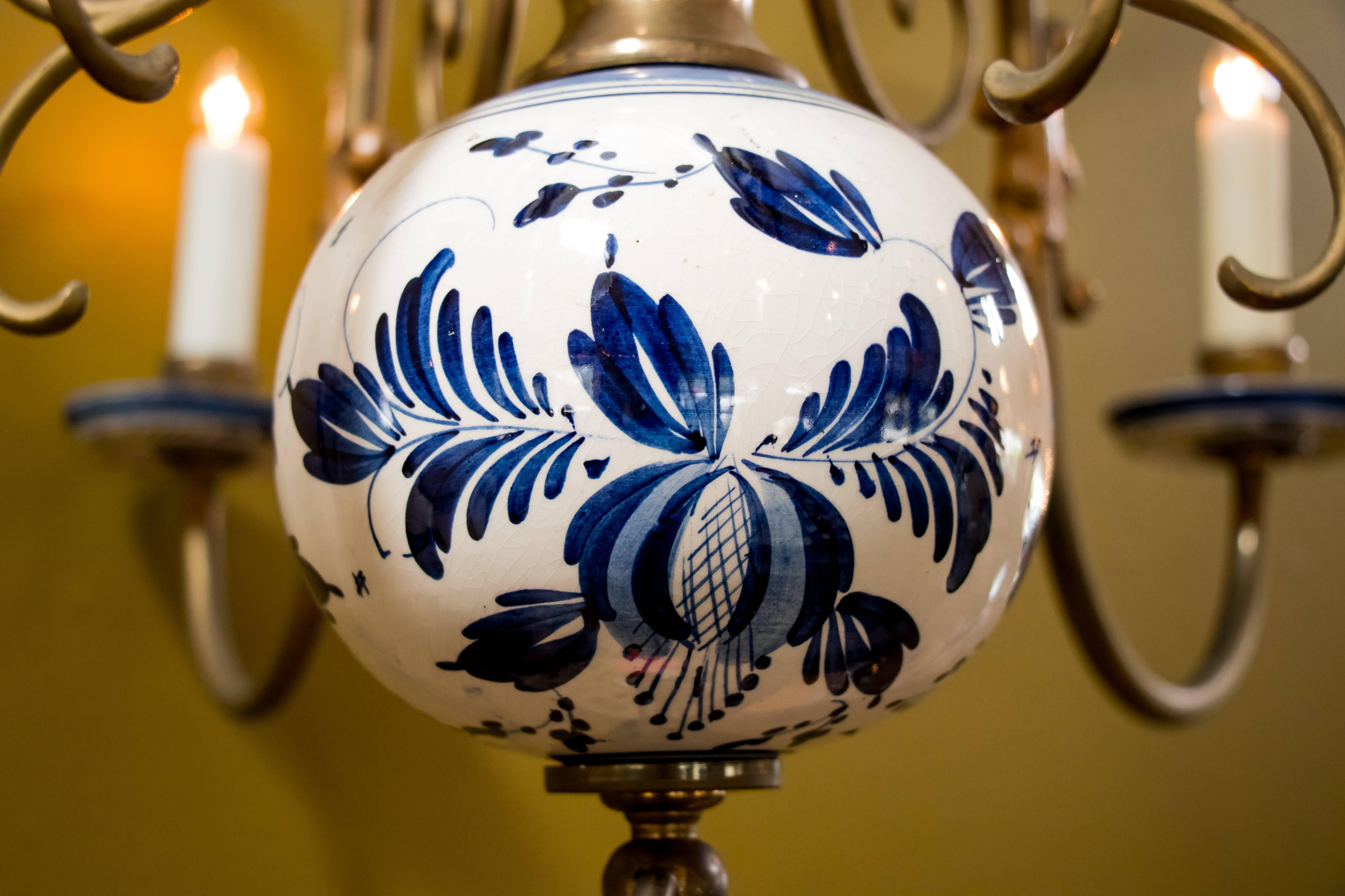 Brass chandelier with hand-painted blue and white ceramic delft ball and bobeche from Holland, circa 1940. Newly wired in the US with all UL listed parts and six candelabra sockets. Comes with matching chain and canopy.