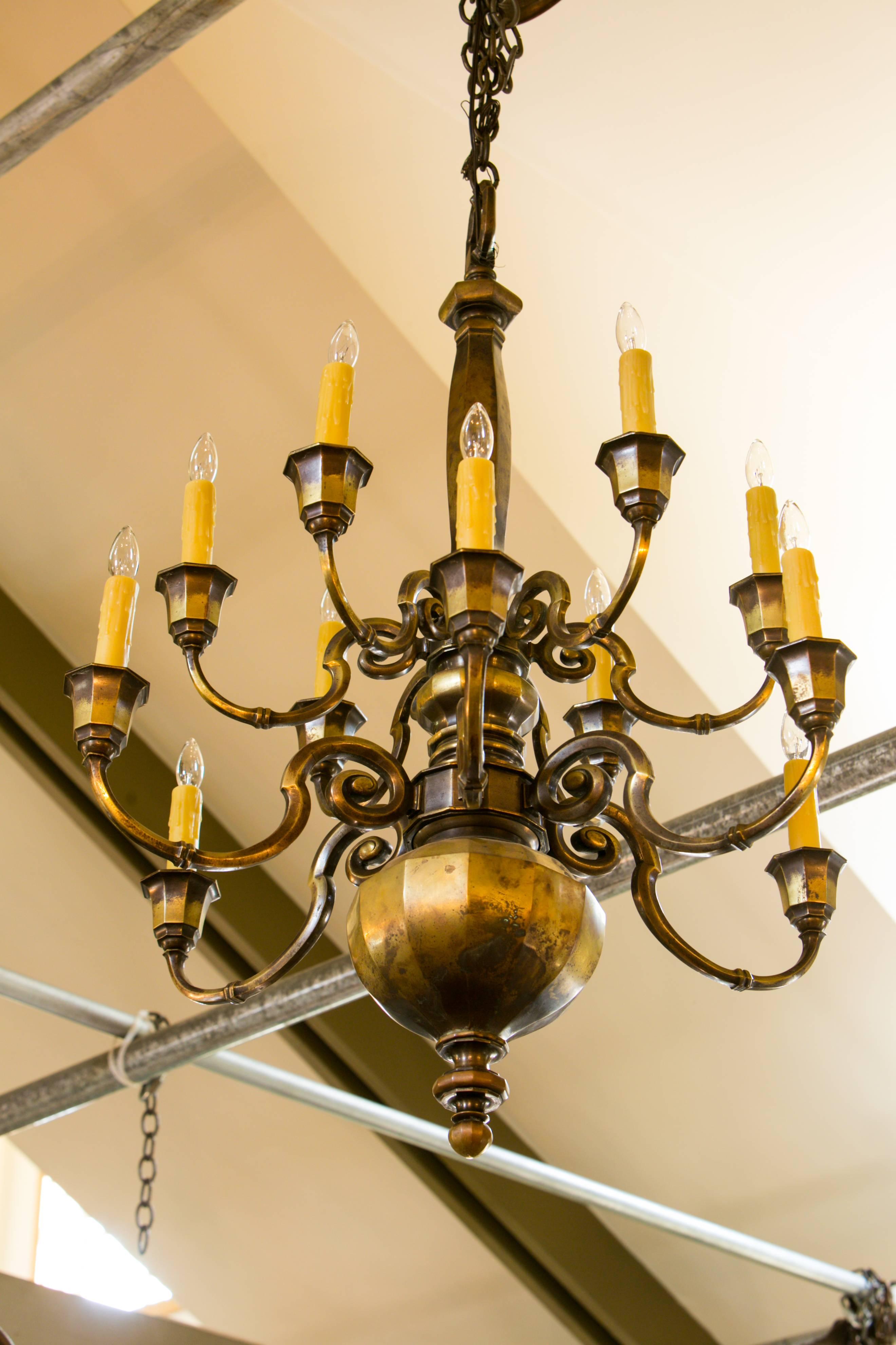 This two-tier chandelier has beautiful bronze iron casting and unusual shape, circa 1900. Newly wired in the US with all UL listed parts and 12 sockets, six on each tier. Comes with chain and canopy.