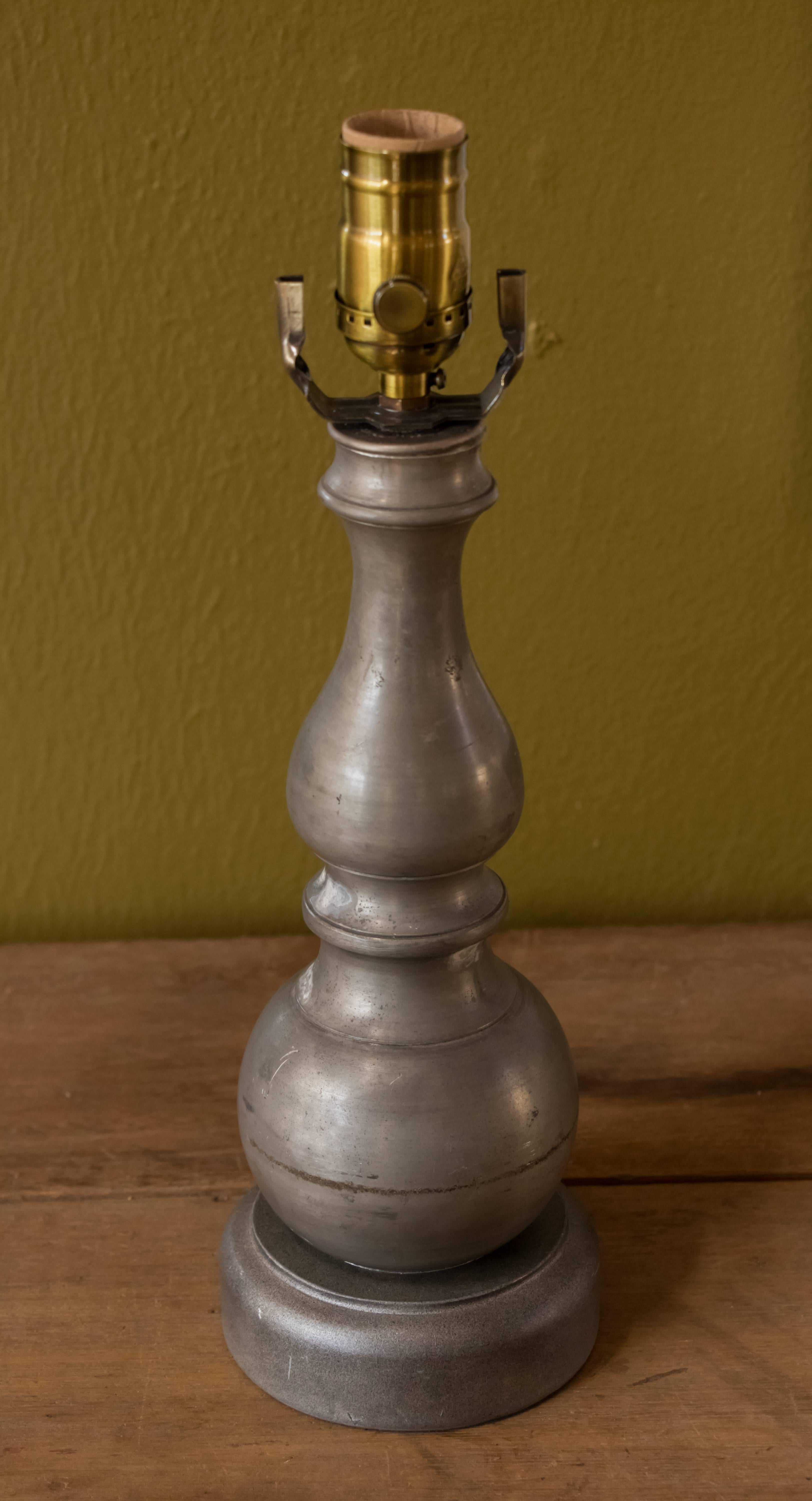Pair of petite vintage pewter table lamps. Same size diameter and height- one has a slightly longer neck above the ball, as photographed. Beautiful, soft patina on the pewter. Newly wired with all UL listed parts and a harp and saddle configuration.