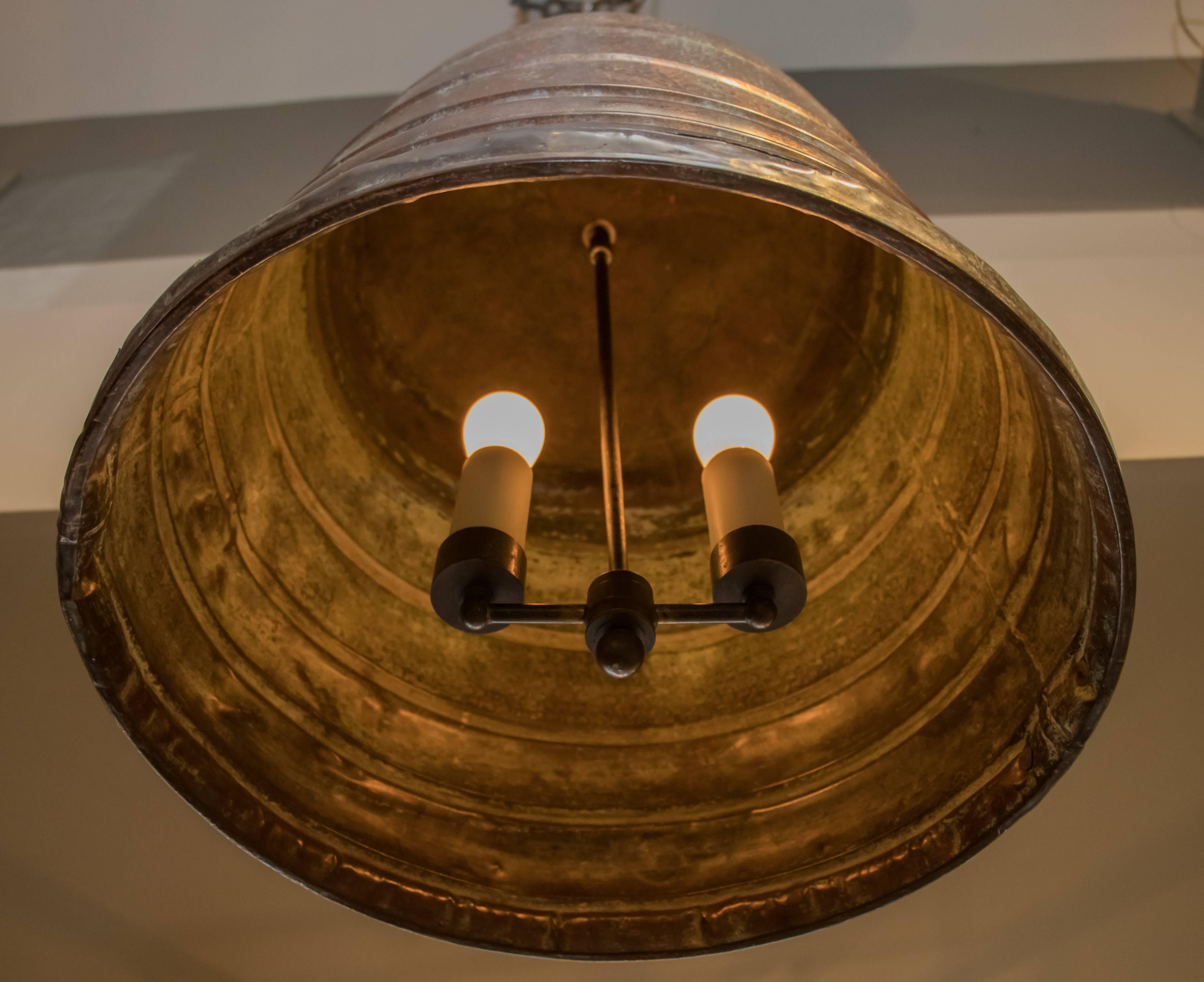 One of a kind, large vintage ribbed and hammered copper pendant light. Newly wired with all UL listed parts and two Edison sockets on a cluster. Comes with chain and canopy. Interesting texture and patina on the body of the light. The light has a