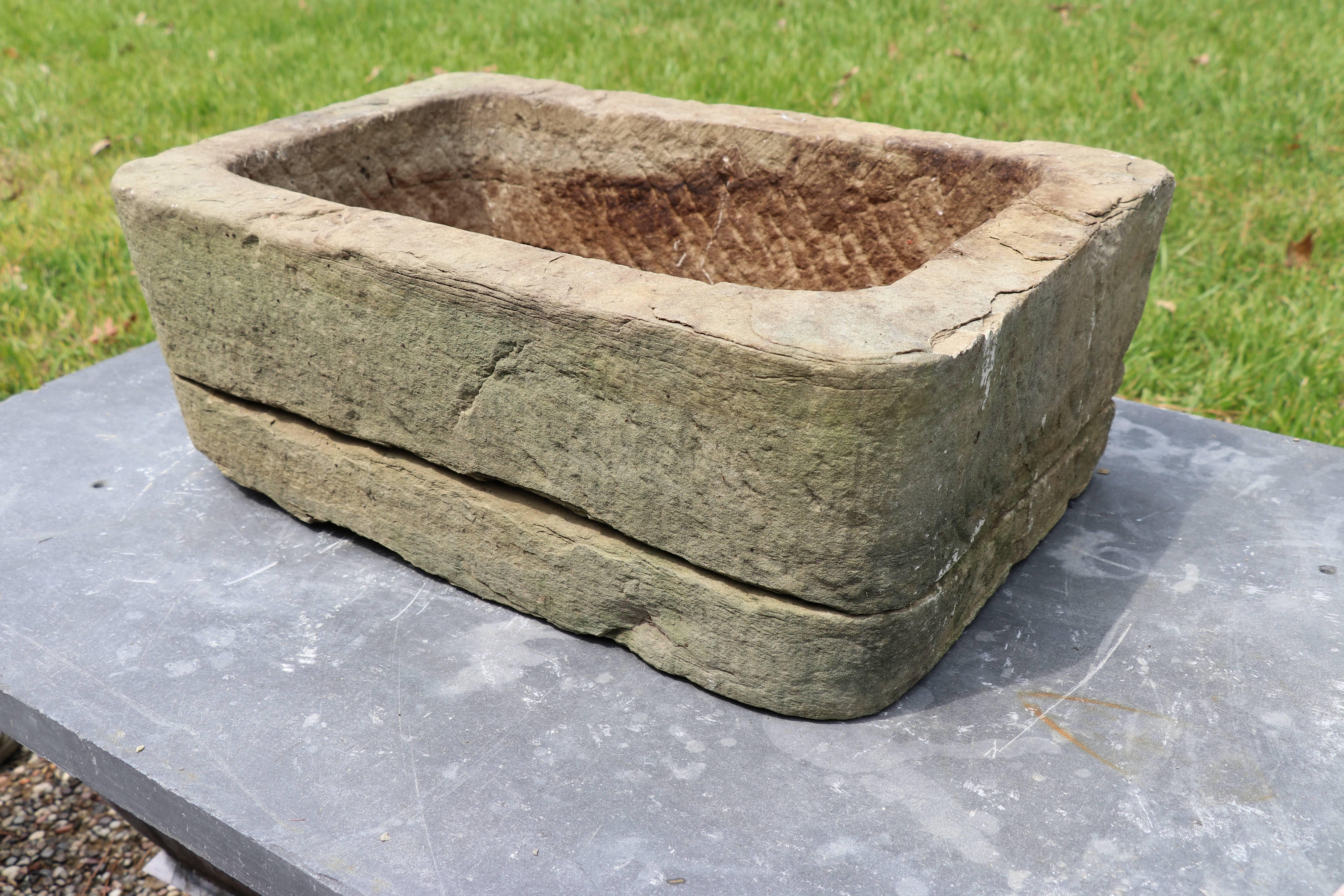 Hand-carved Belgian stone planter (circa 1900): rectangular in shape, this limestone, or bluestone, is comprised of two pieces. Top portion fits snugly on the bottom slab. Item is not meant to be a vessel for holding water.