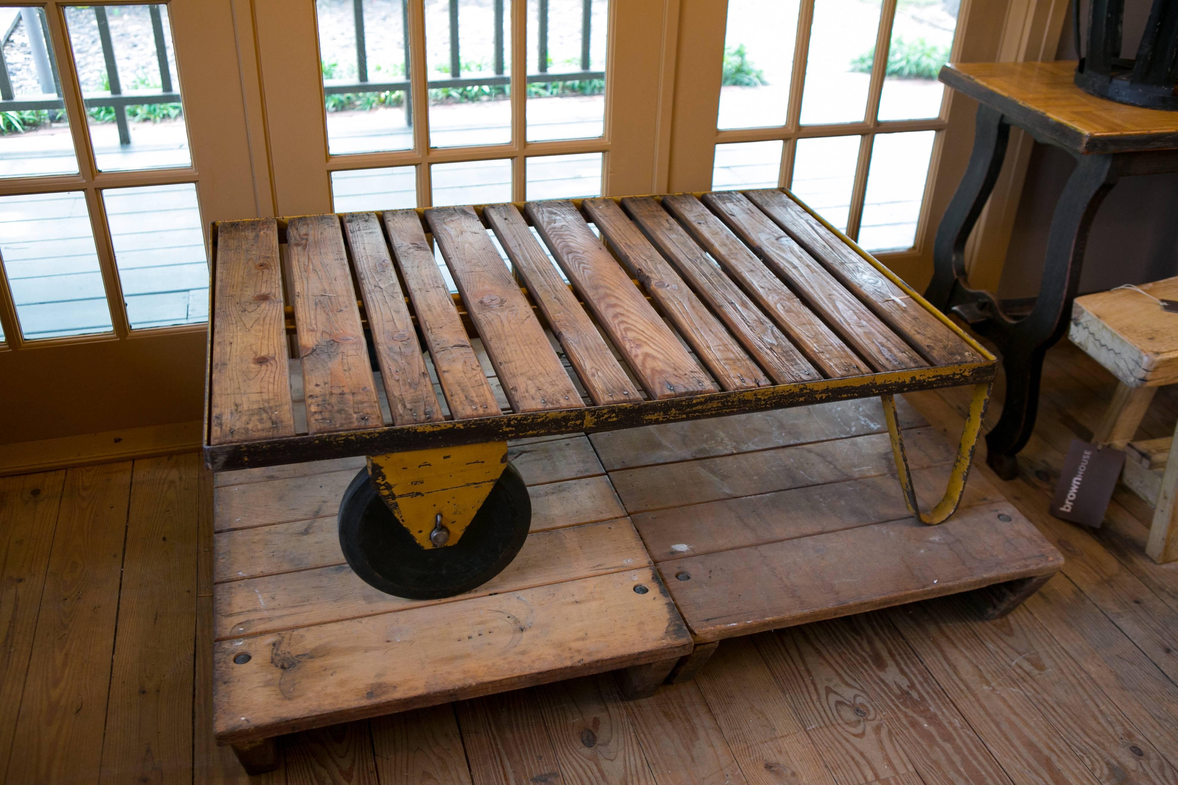 Industrial iron cart with wood slat top and two steel wheels. From Belgium, circa 1940s. Would make a great low coffee table. All original parts with original paint.