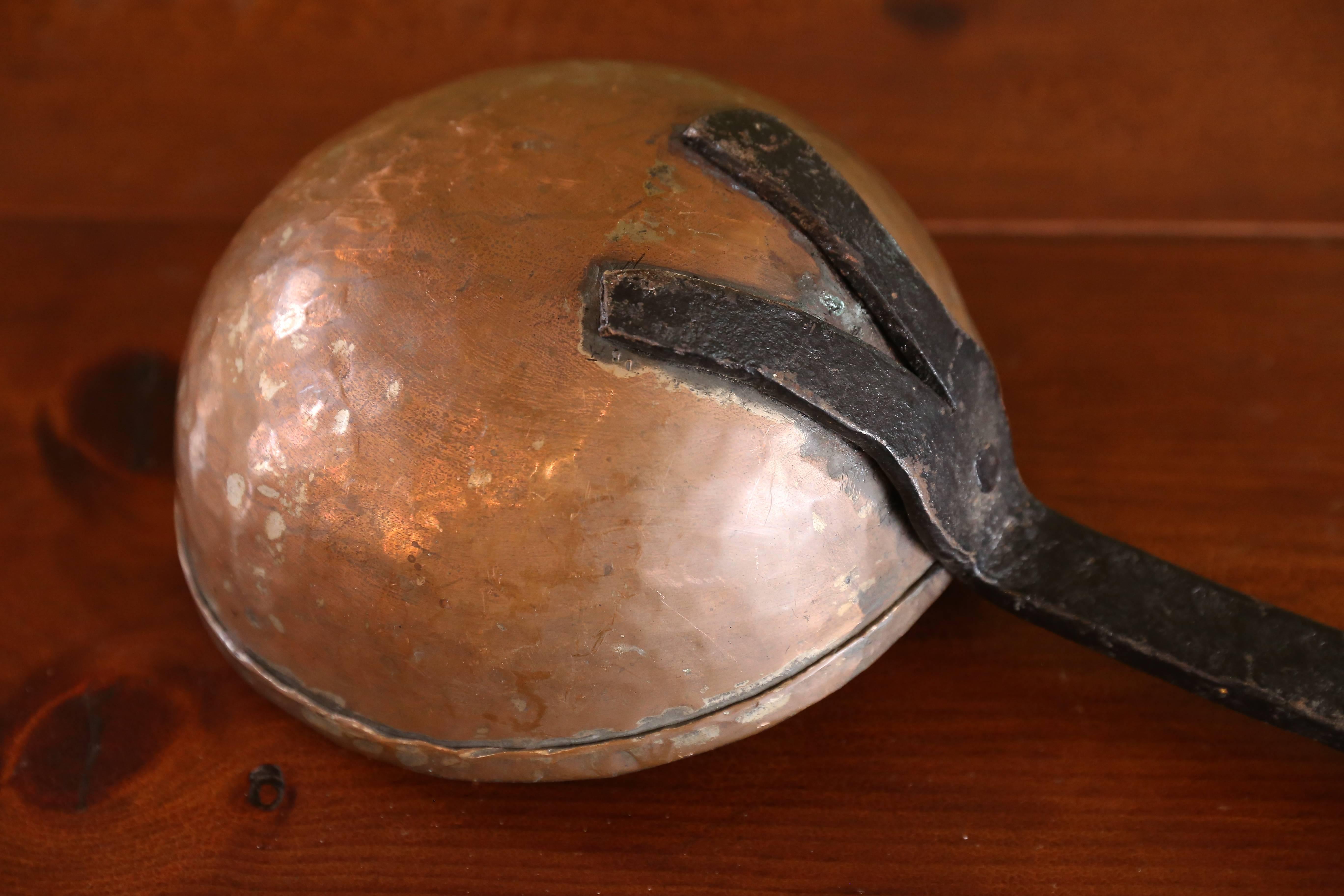 Over-sized antique copper and iron ladle: wonderful giant French hammered copper ladle with fine forged iron hooked handle. All hand-forged and original circa 1920s. Gorgeous decorative accent that is much larger than it appears in photographs (see