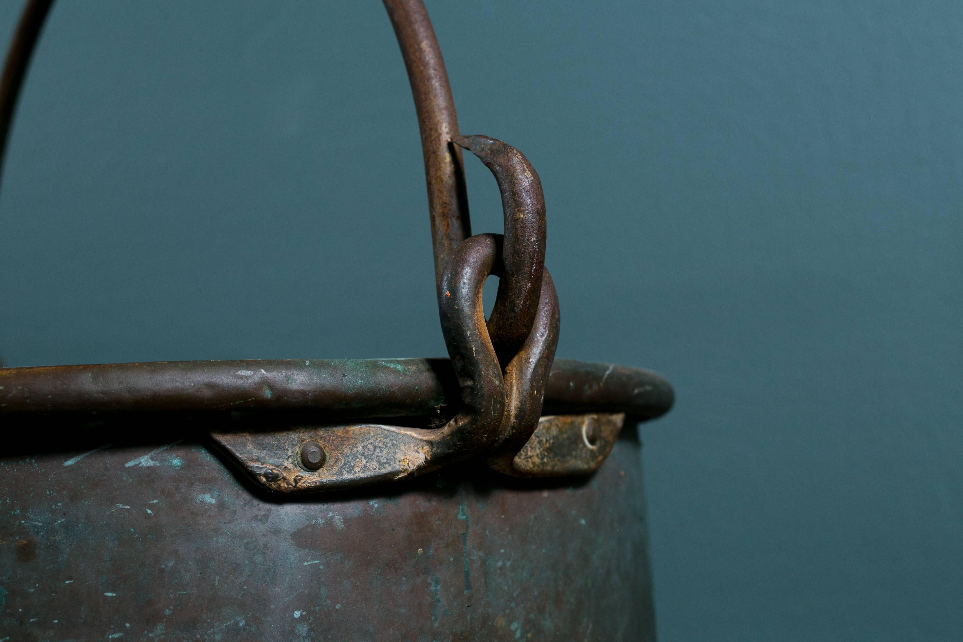 Antique French copper pot or bucket with iron handle (circa 1890). All hand-forged with beautiful verdigris patina. Multiple pots available - all similar in size but each one-of-a-kind. Makes an attractive decorative accessory or container for