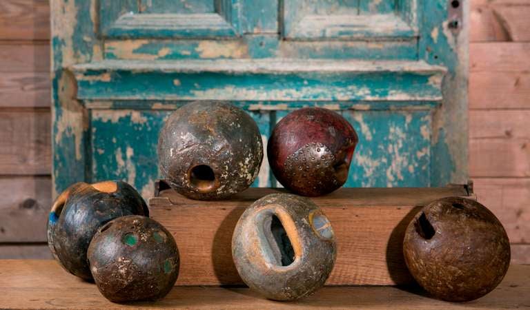 Assorted antique European game balls: hardwood game balls in mixed colors and reinforced with iron strips and brads (for protection). Various sizes and weight available (total of 15). A great accessory for a table top or bookshelf. Priced separately