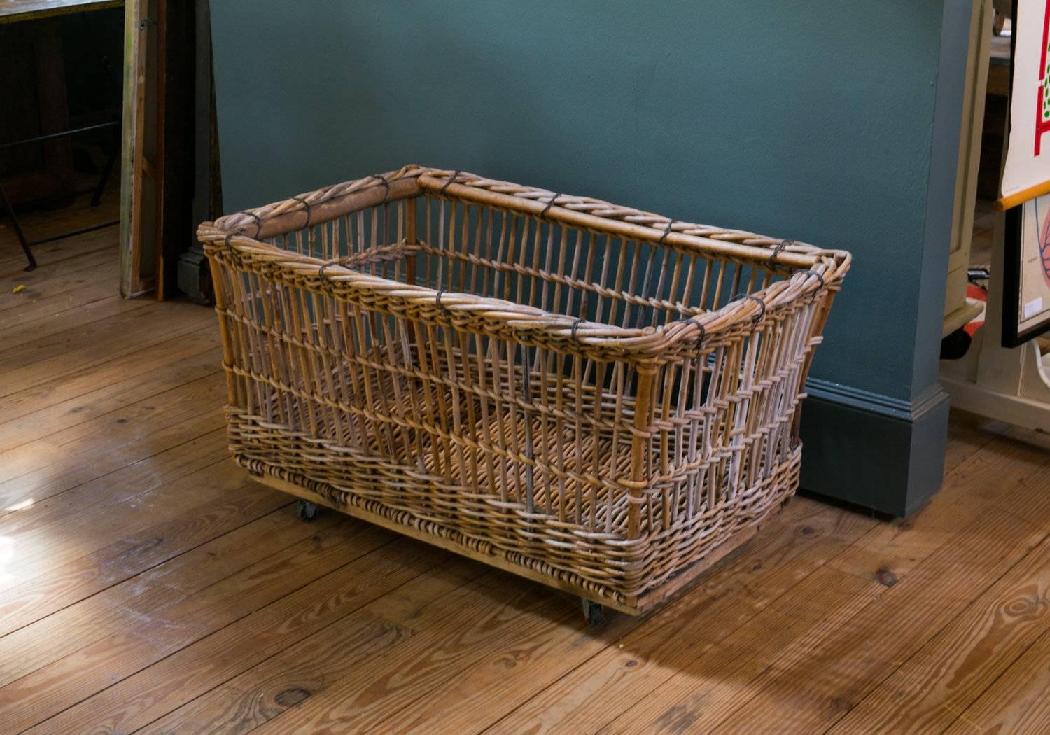 This large-scale vintage rattan cart was used in a Belgian linen factory in the 1920's. The cart is on four wheels. Three carts available, which vary slightly. Price is for one cart.