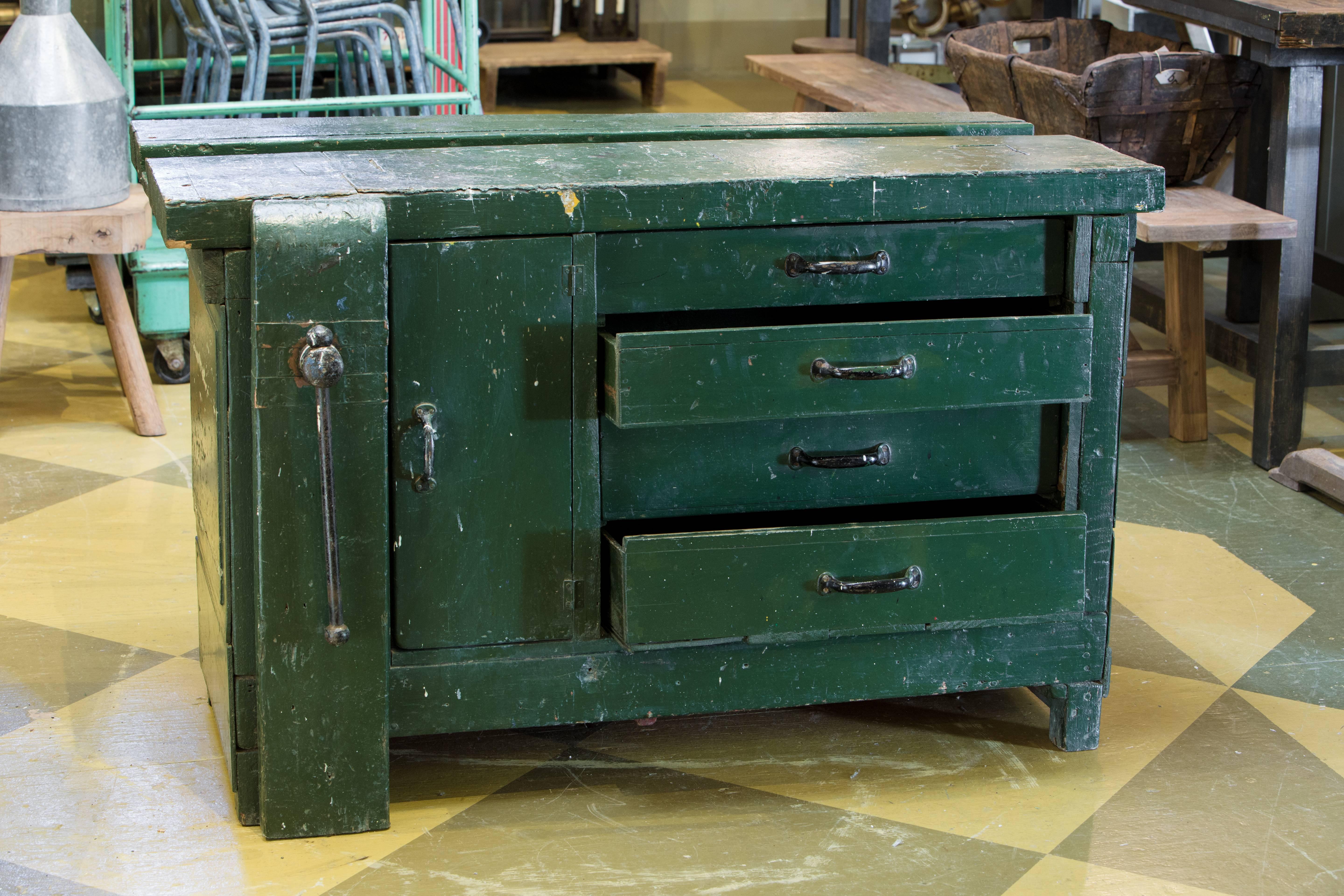 Belgian wooden work table/storage cabinet with original green paint, circa 1920. Four drawers, one cabinet. Original hardware and clamp. Top drawer has a divided section. Additional photos upon request.