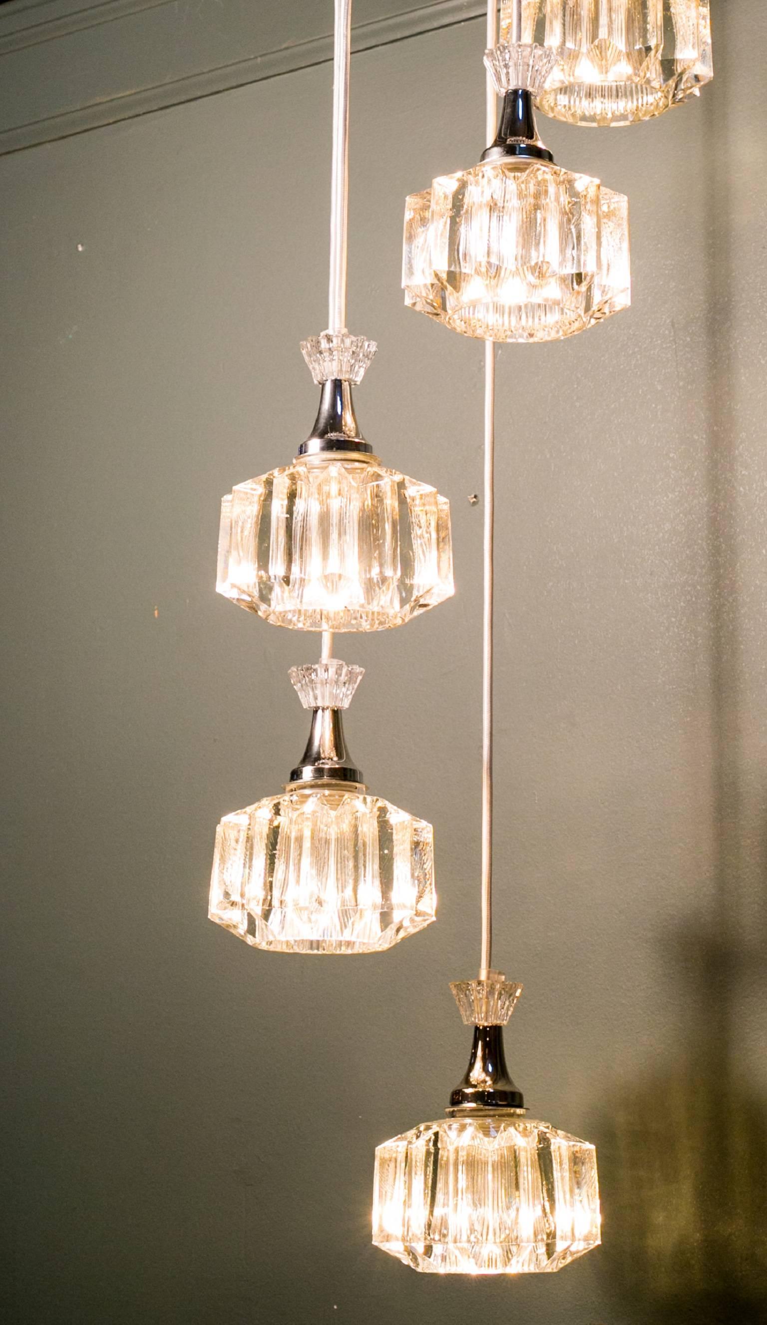 Waterfall style light, circa 1960. Features five blow molded lights on one canopy with polished nickel hardware and banding. Beautiful quality with heavy glass. Newly rewired in the USA with all UL approved parts. Length of the pendants can be
