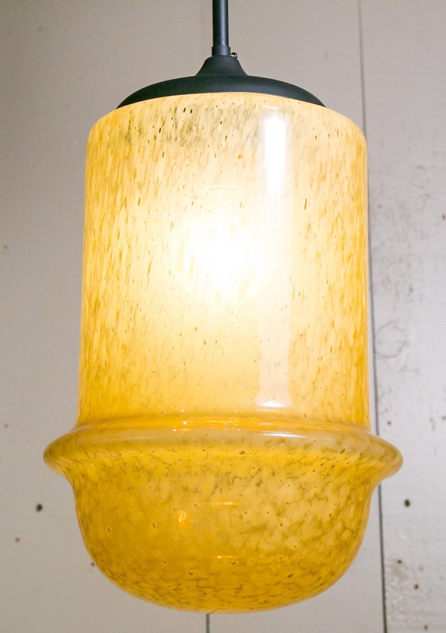 Mid-Century Modern yellow hand-blown glass light by Mazzega.  Interesting speckled color variations in the glass.  Glass dome rests on a on dark painted
metal rod with one porcelain Edison Socket.  Can take up to a 100 watt bulb. Newly rewired in