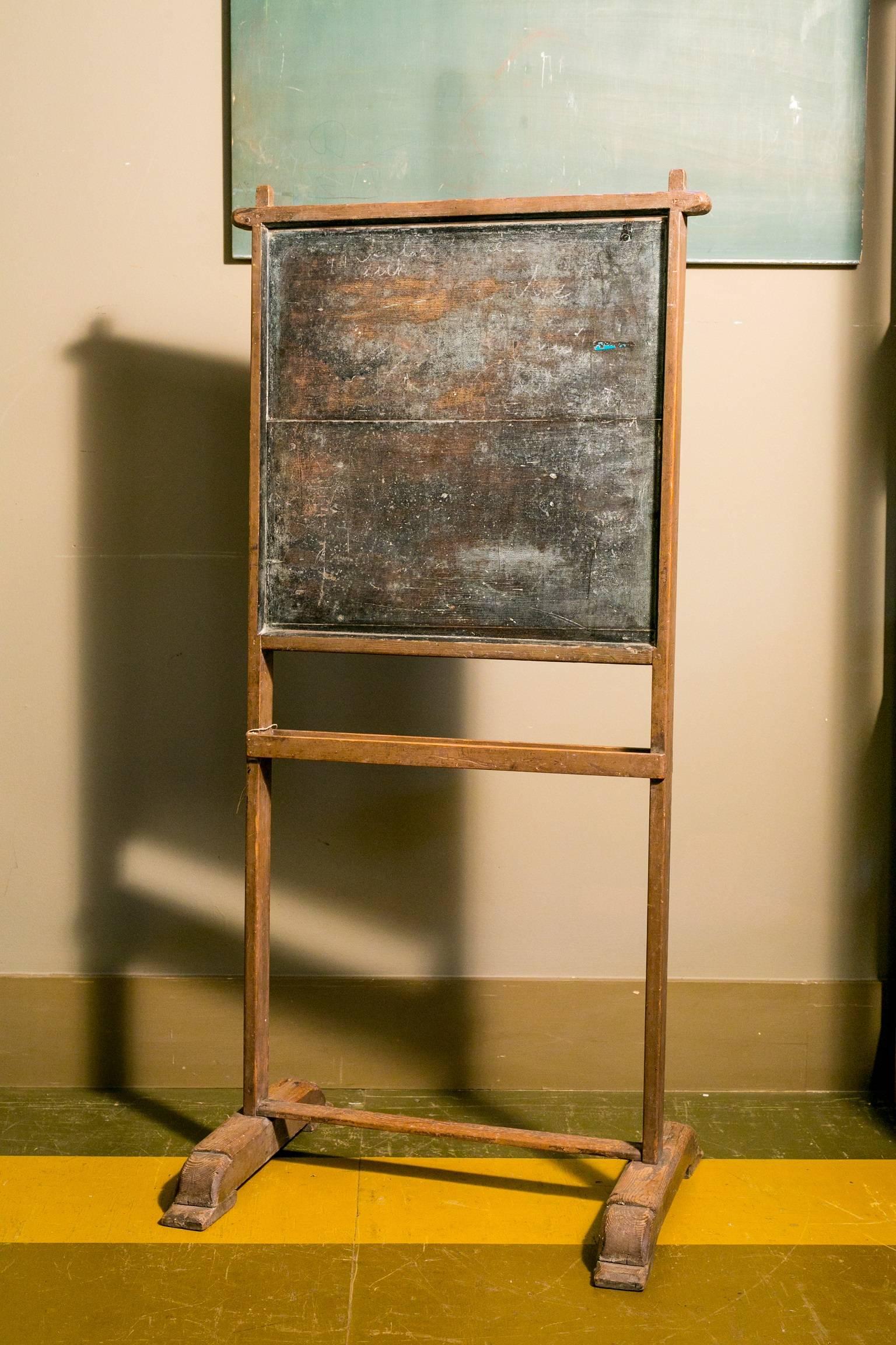 Charming dual-sided wooden chalkboard on stand with chalk tray.  From Belgium, circa 1920.