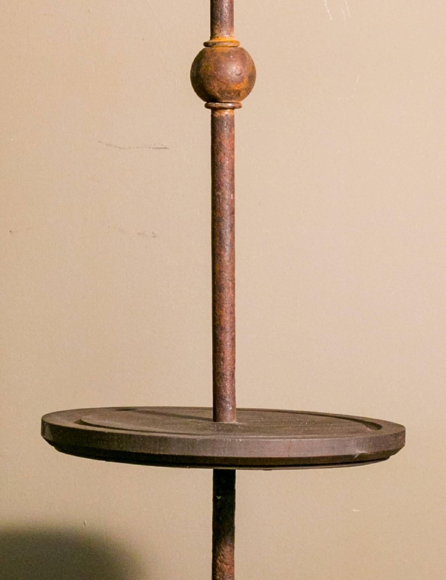 Custom, black-smith made iron floor lamp with grooved, round wooden center, painted to match finish. Newly wired in the USA with all UL listed parts. Sold without bulb and shade. Diameter is of the base, round wooden center diameter is 13 inches.