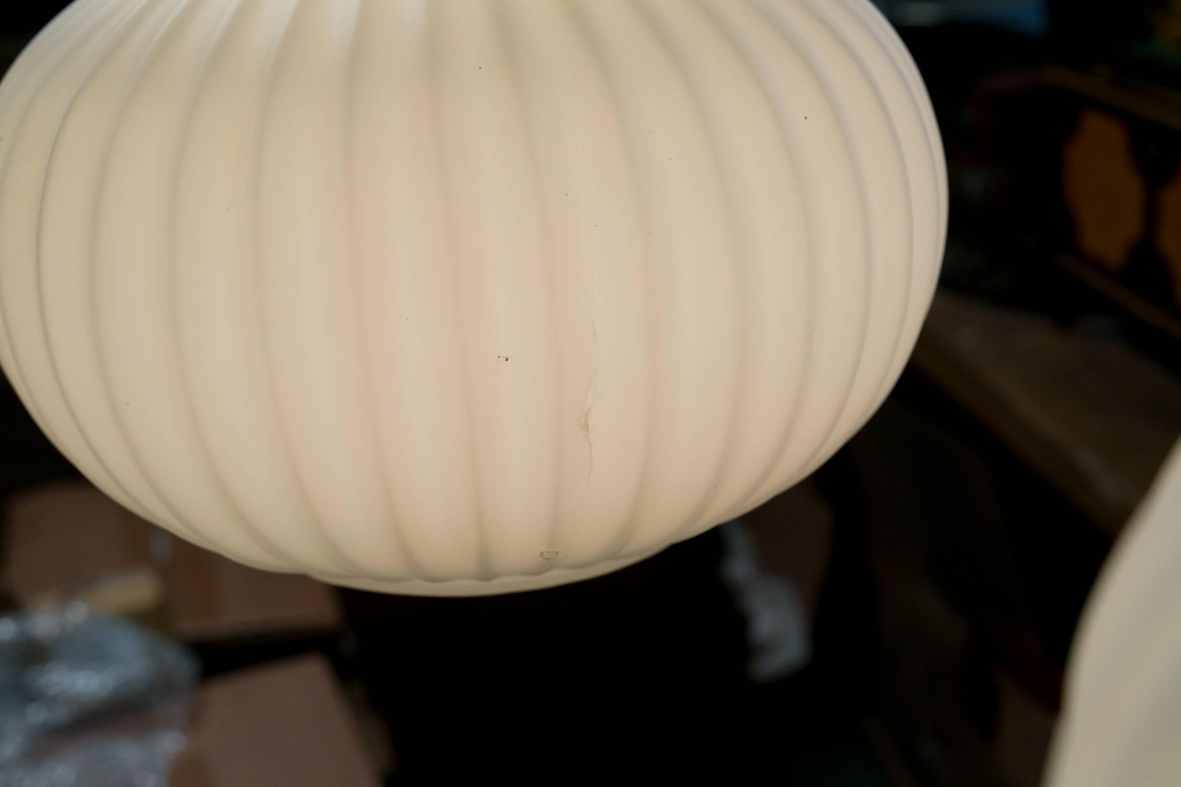 Three blown milk glass shades per light with teakwood and brass collars. Newly wired in the USA with all UL approved parts. Comes with original wood canopy. One globe has a minor crack on the inward facing side, as shown in second photo. Price is