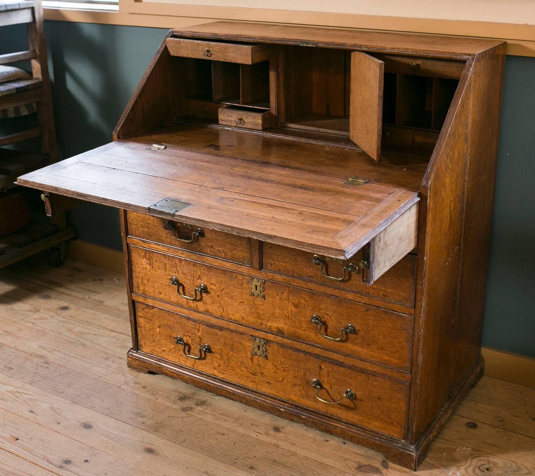 Writing desk from France, circa 1870. Features six larger drawers on the bottom and six small drawers inside the desk compartment. Three pigeon hole slotted areas and a main compartment also featured inside the desk area. Has two pull-out support