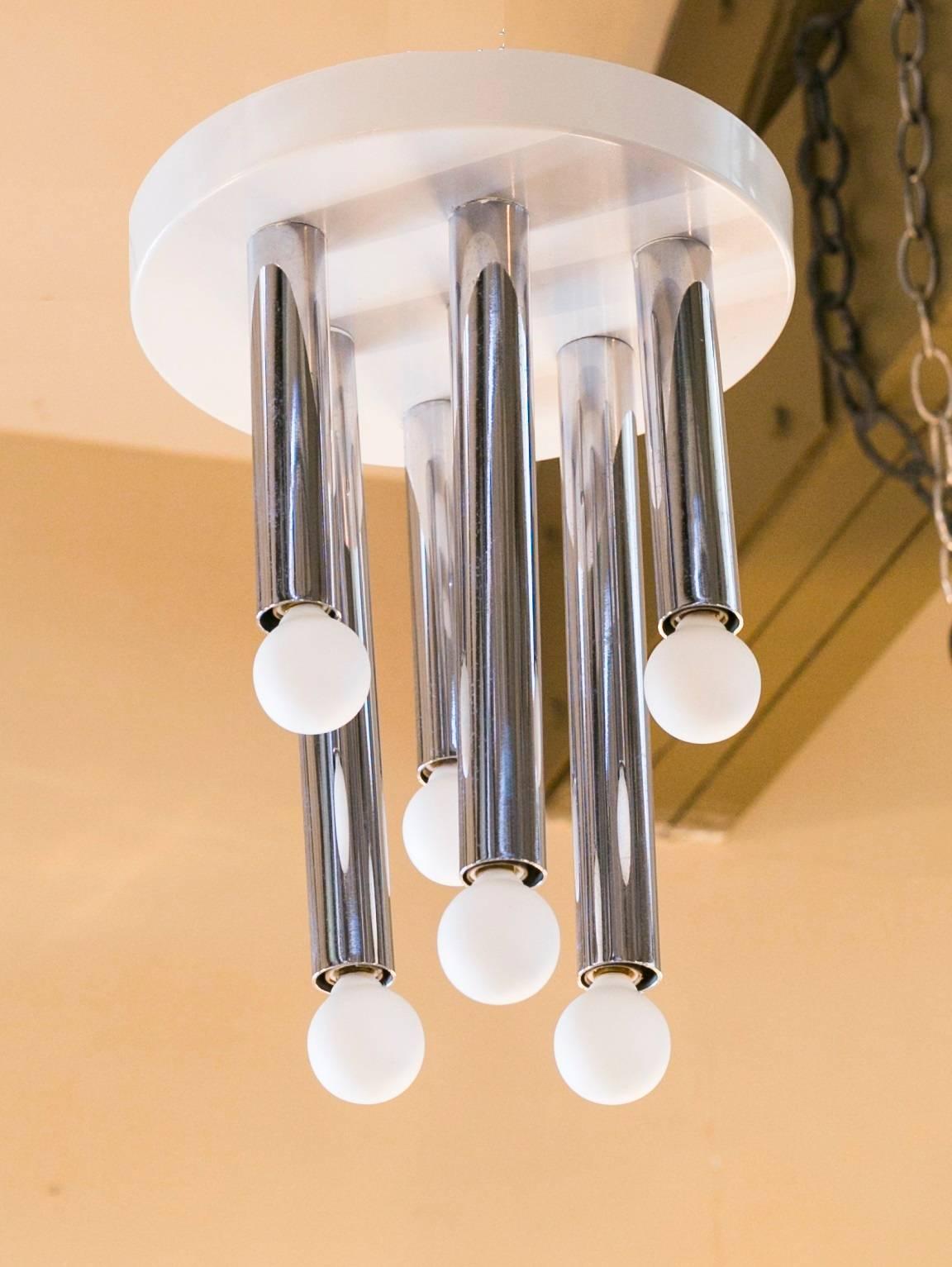 Chrome tubes on a ceiling mount plate with varying lengths of sockets (three long, three short). White painted canopy/base. Newly rewired in the USA with all UL listed parts and six candelabra sockets. Height is to the bottom of the longest socket. 