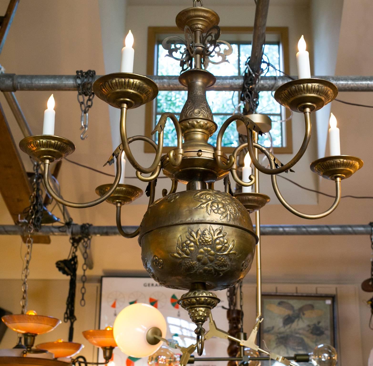 Highly unusual and rare, classic repousse' antique brass chandelier from France, circa 1900. In the Baroque style with an embossed floral motif on body with wonderful proportion. Beautiful bobeche and detailed casting. Newly wired with all UL listed