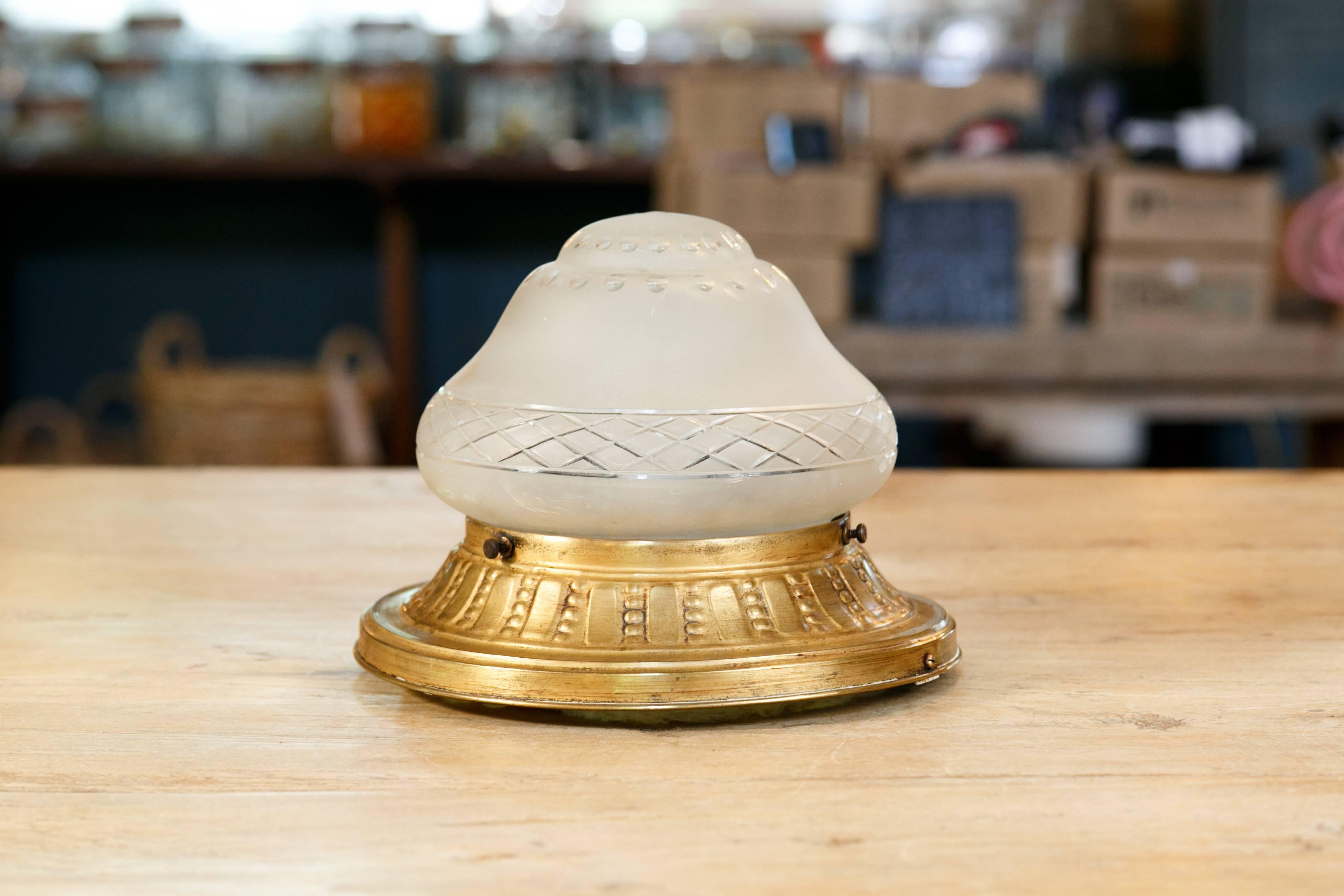 Ceiling mount light with single porcelain Edison socket under an etched, frosted glass dome. Embossed banding on the brass collar. All original, circa 1890.  Perfect for rooms with low ceilings.
 