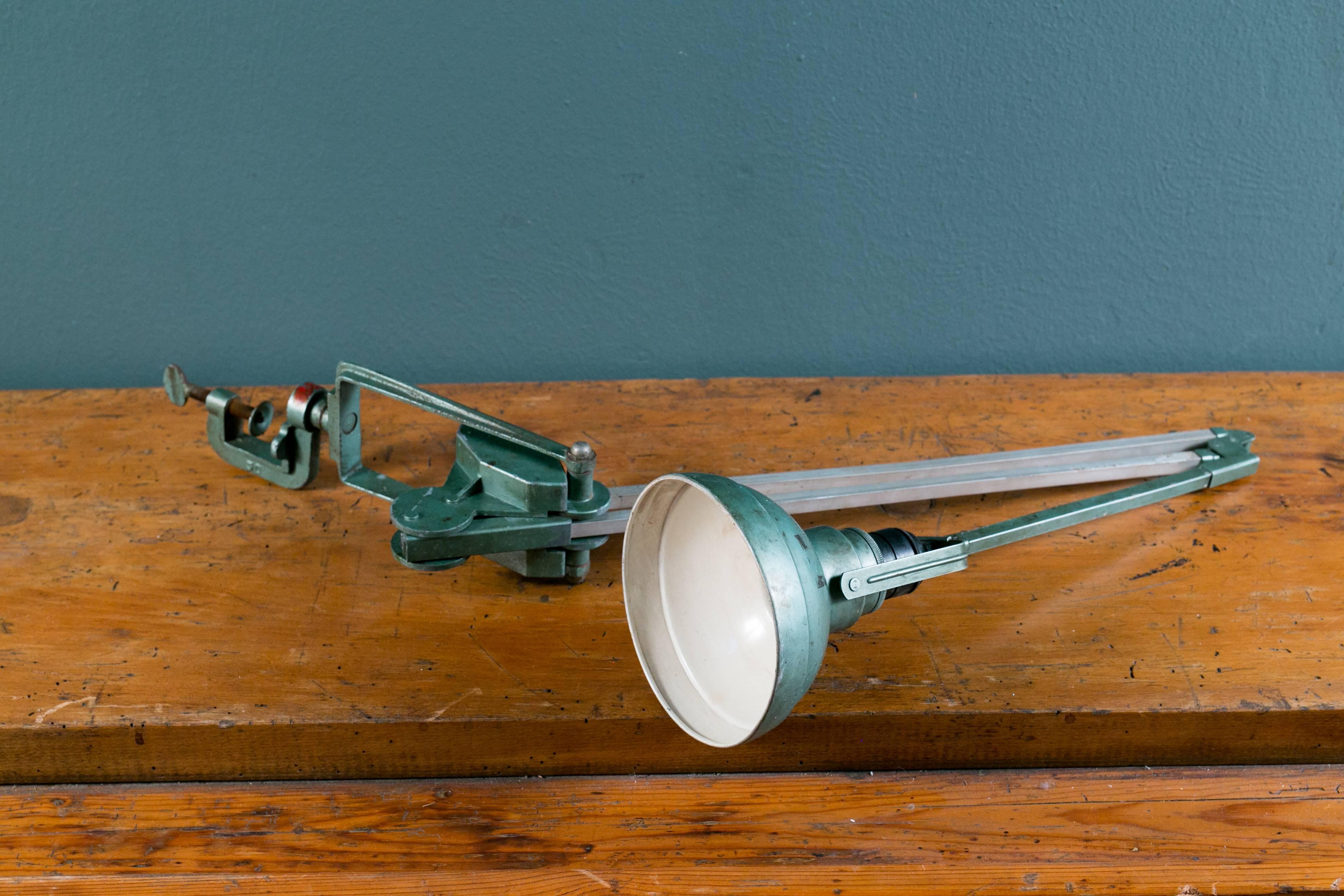Erpe industrial drafting lamp: metallic green mechanist or drafting table lamp manufactured circa 1940 by the Belgian company Erpe. Supported by an articulated arm attached to desk by a screw clamp. Neck hinged to weighted swinging base. Shade turns